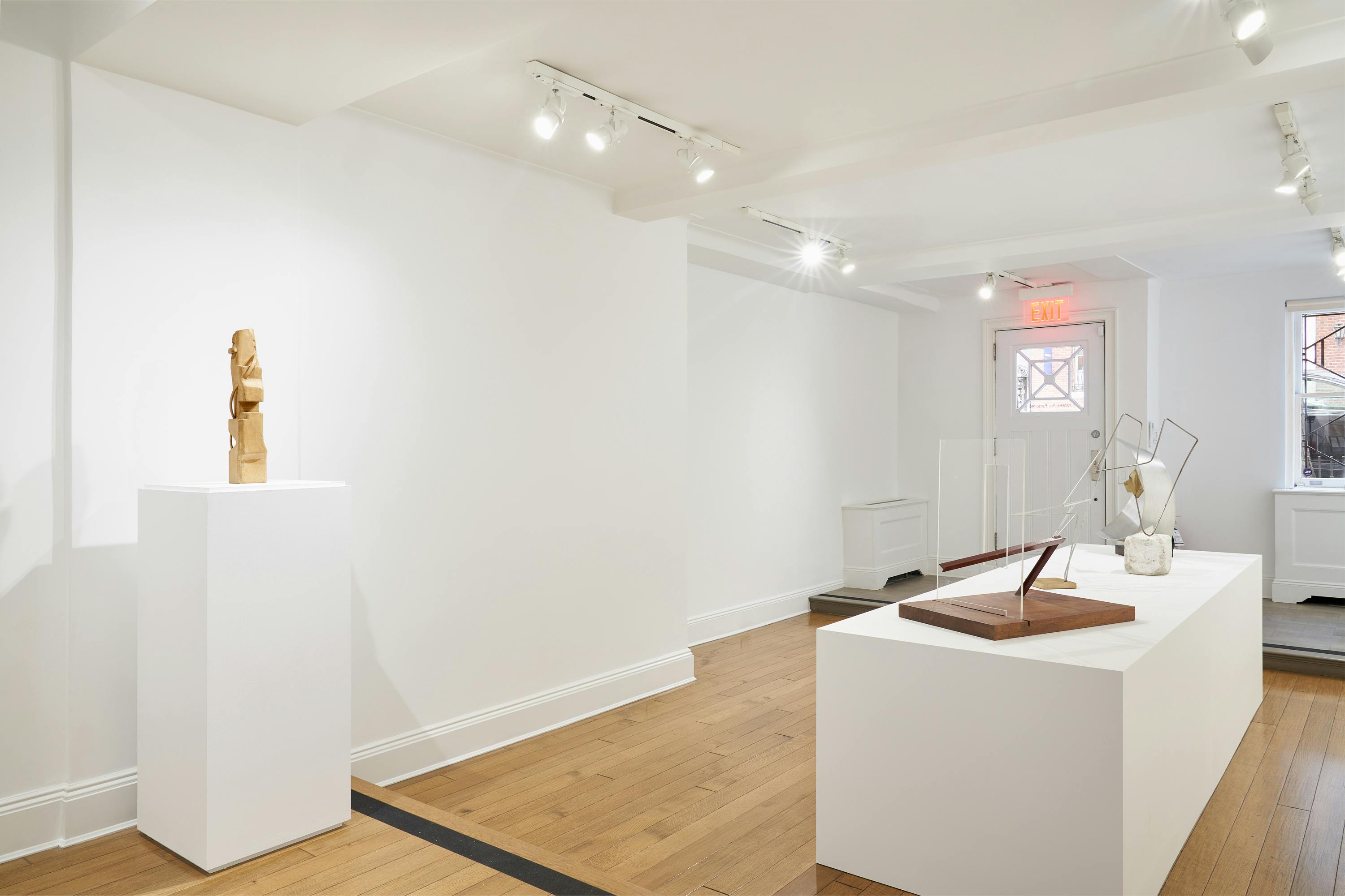 Gallery view of From Surface to Space exhibition showing five free-standing sculptures, and six wall-mounted drawings.