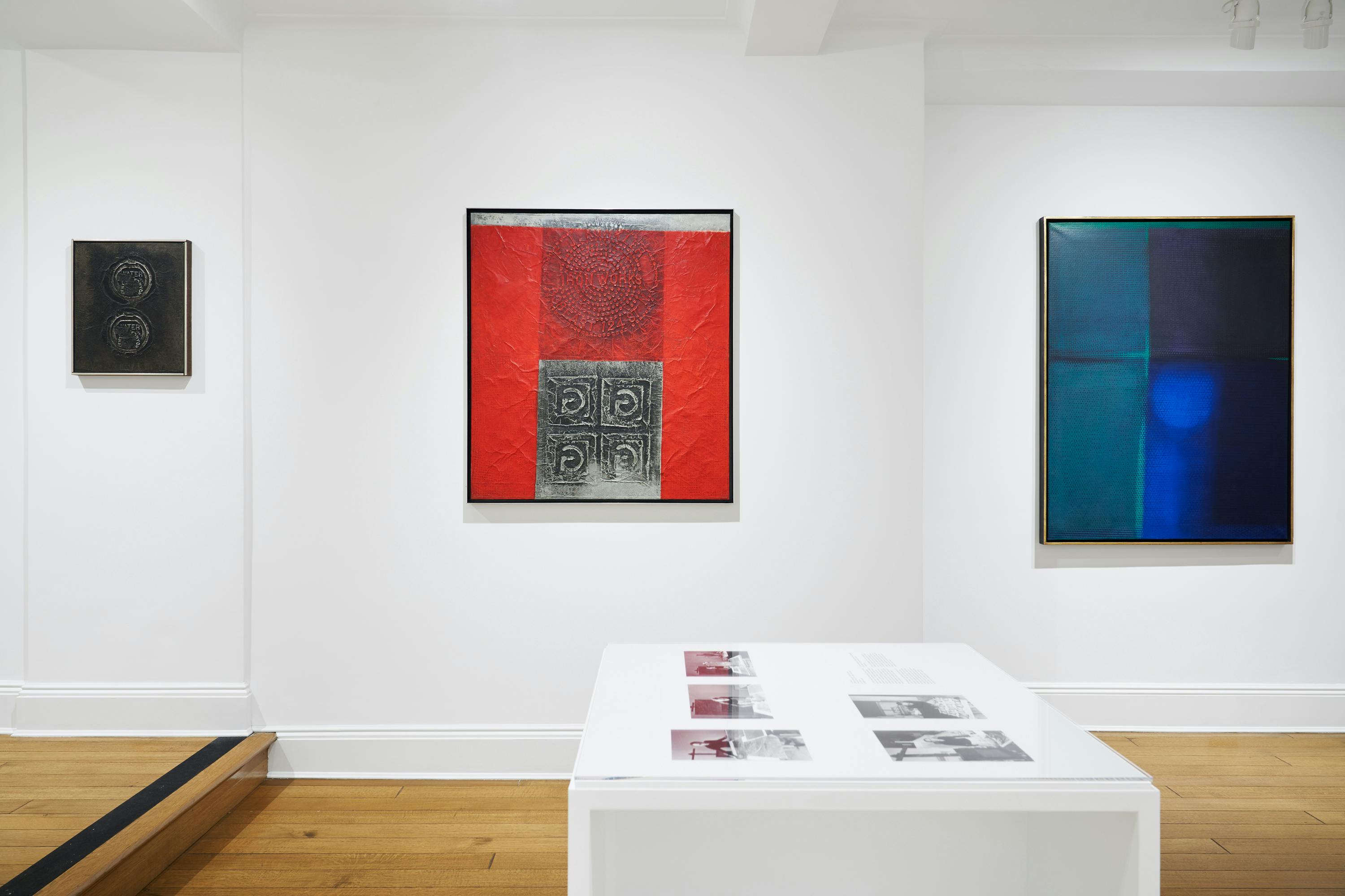 Installation view of a vitrine and three aluminum foil works by José Antonio Fernández-Muro.