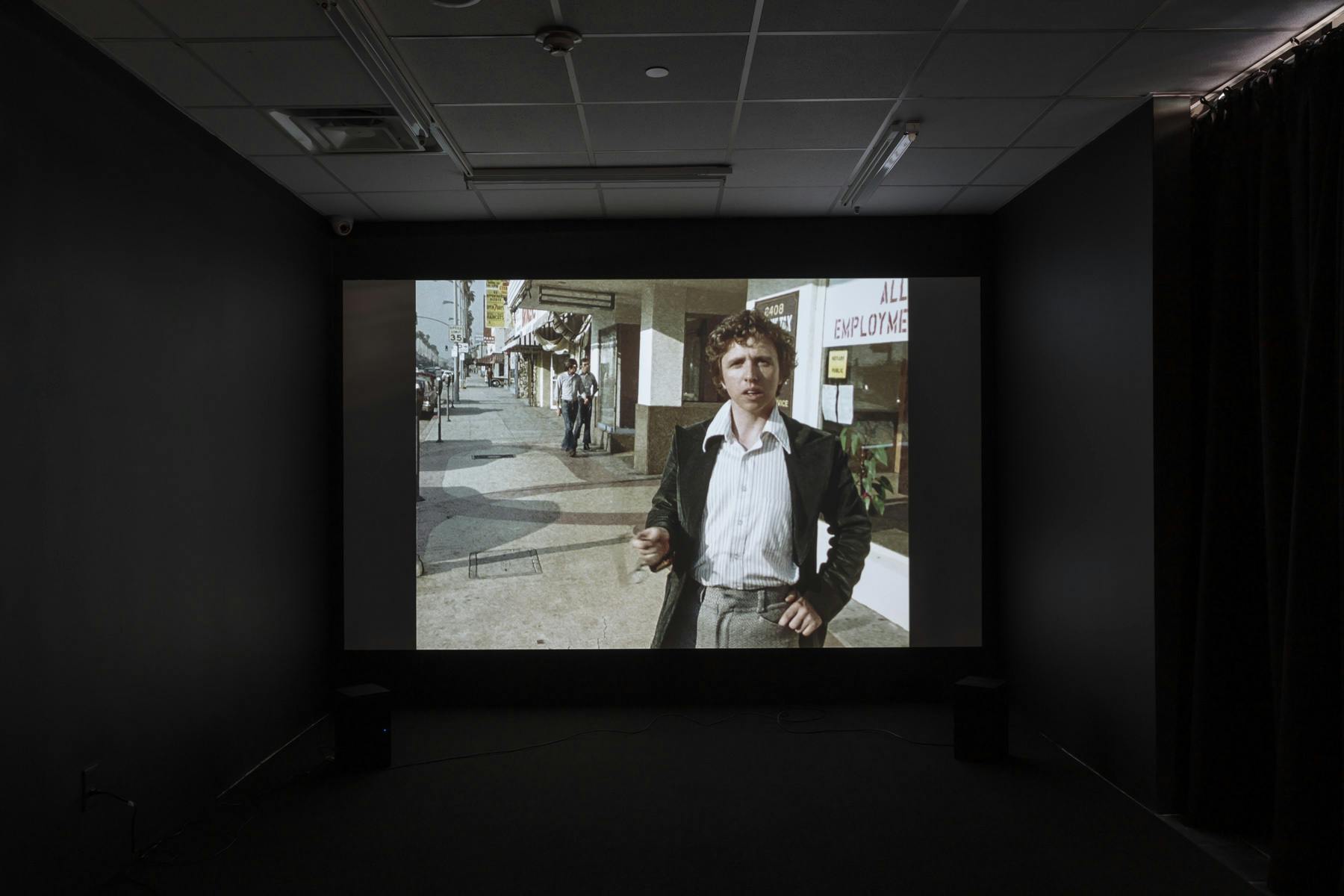 Installation view of a video projection in a dark room.