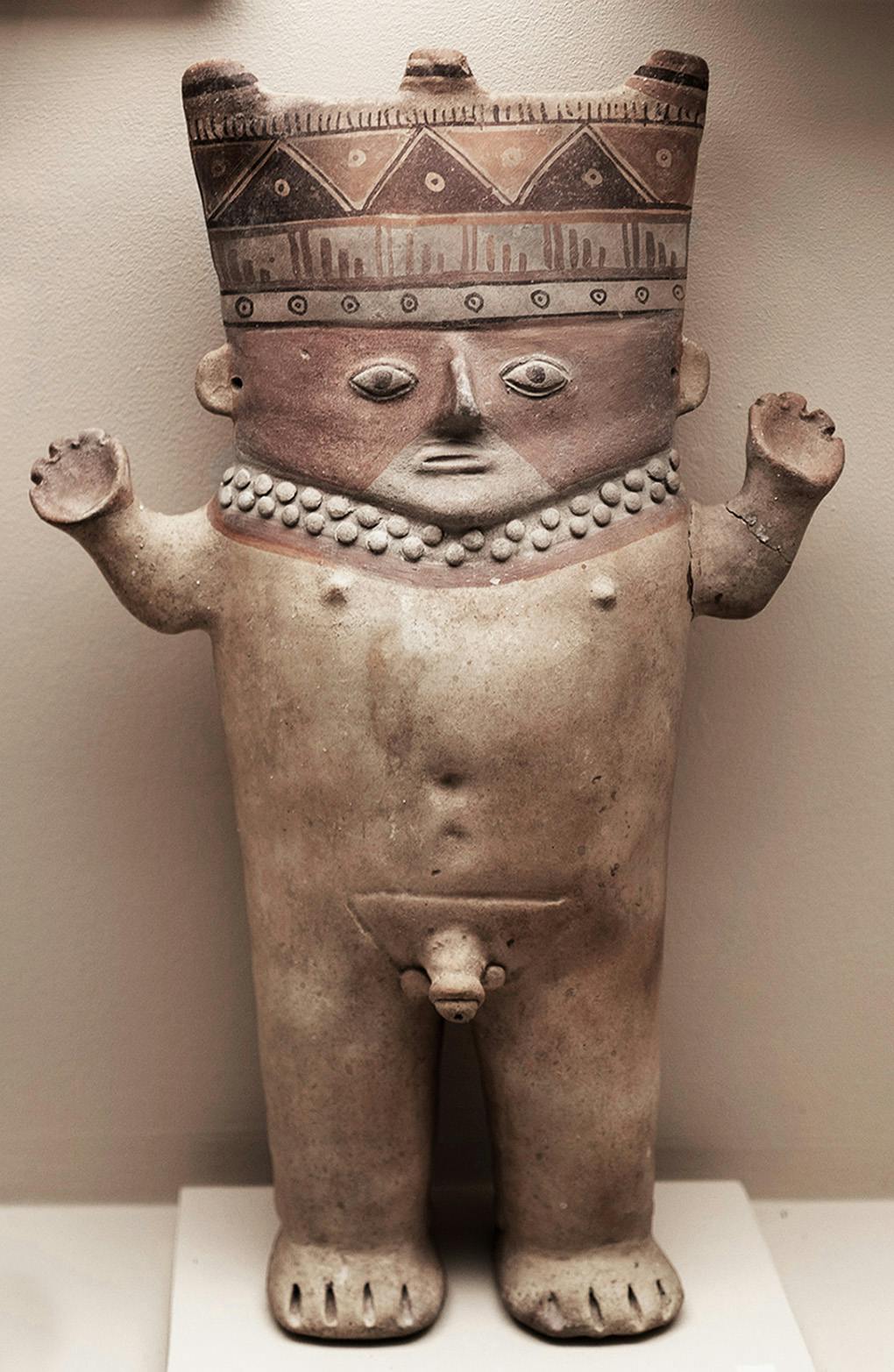 Ceramic of crowned naked figure raising its arms