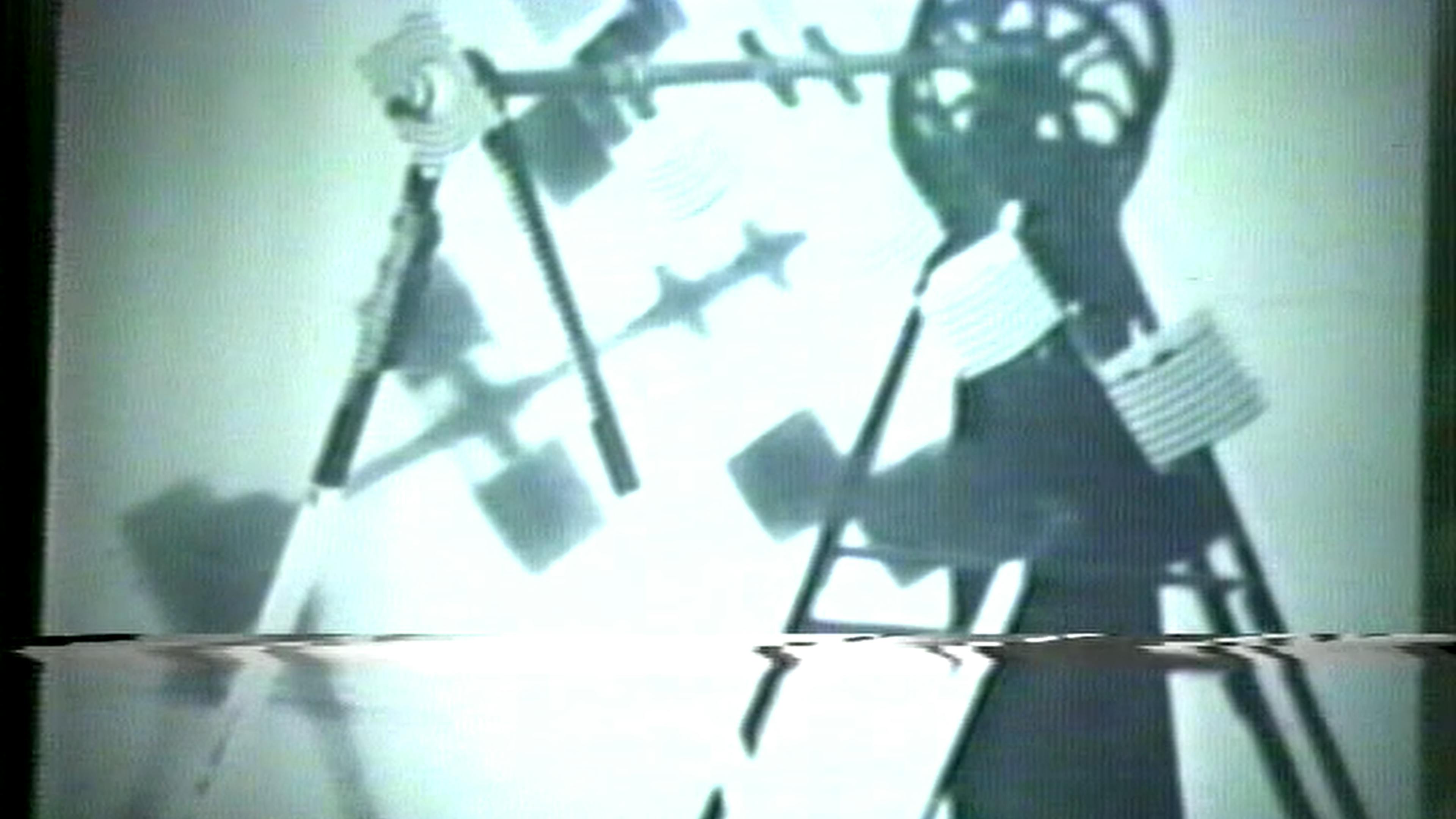 Black-and-white film still of wheels and gears