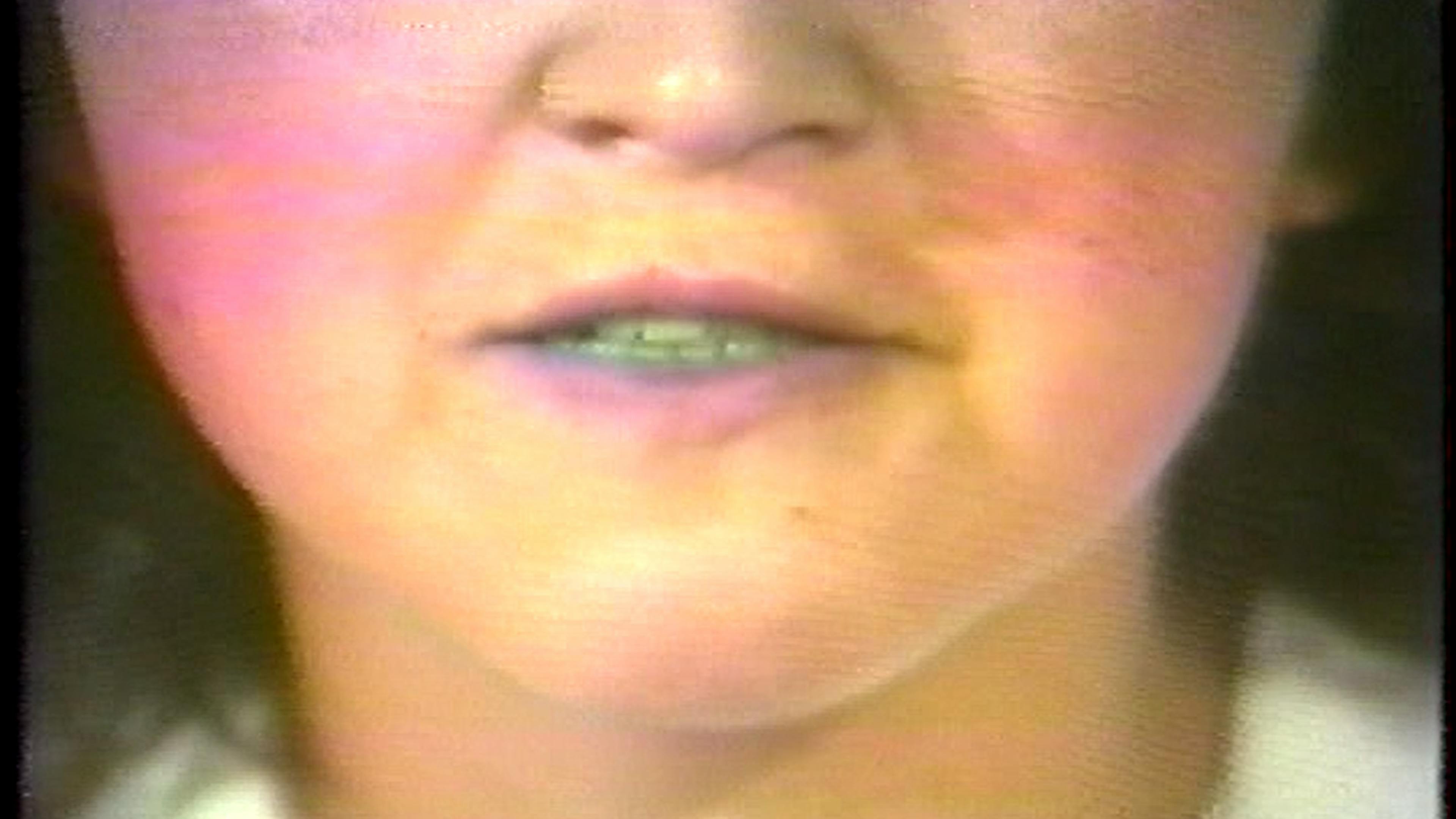 Color film still of mouth close-up