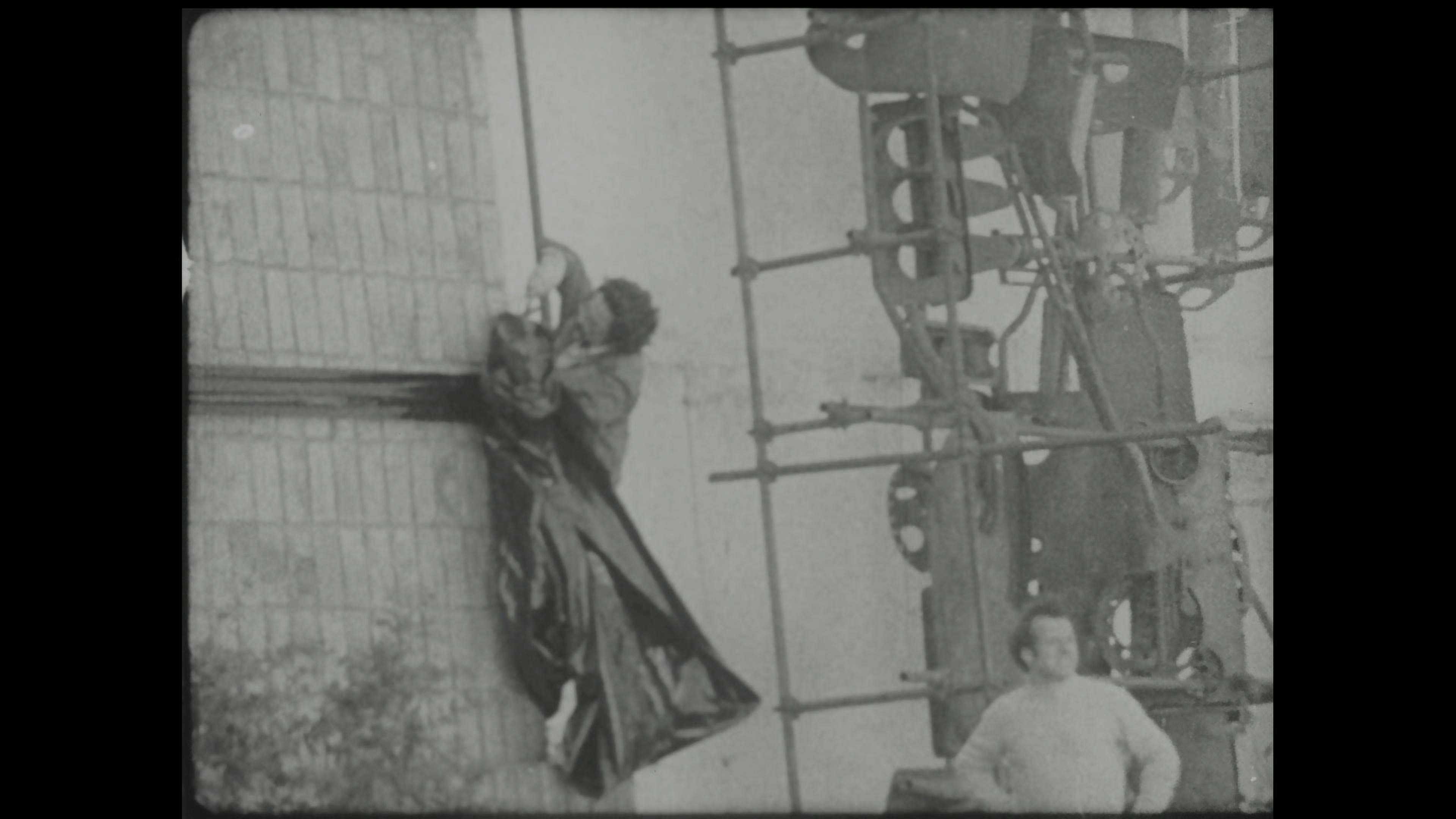 Black-and-white film still of public art event