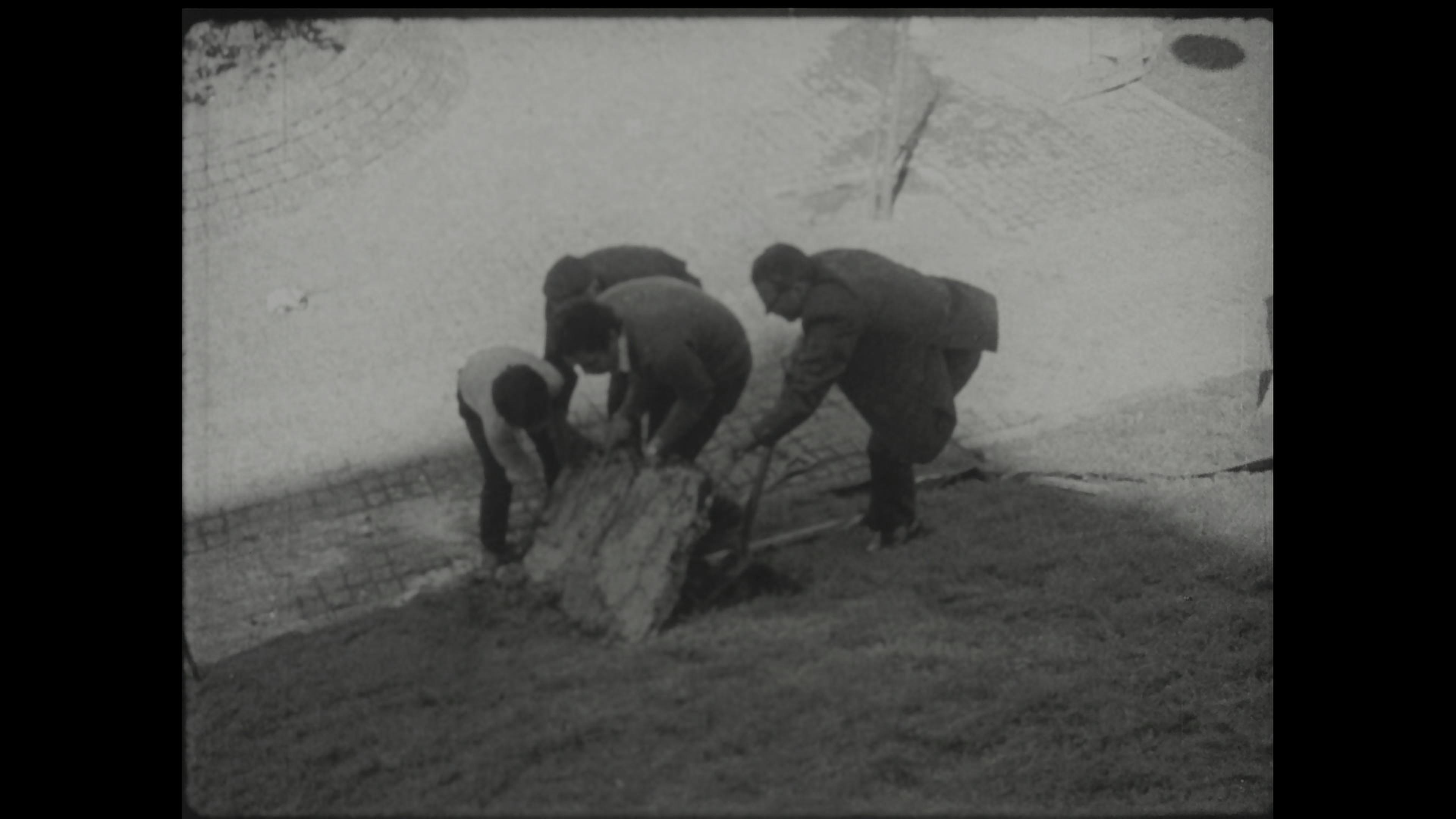 Black-and-white film still of public art event