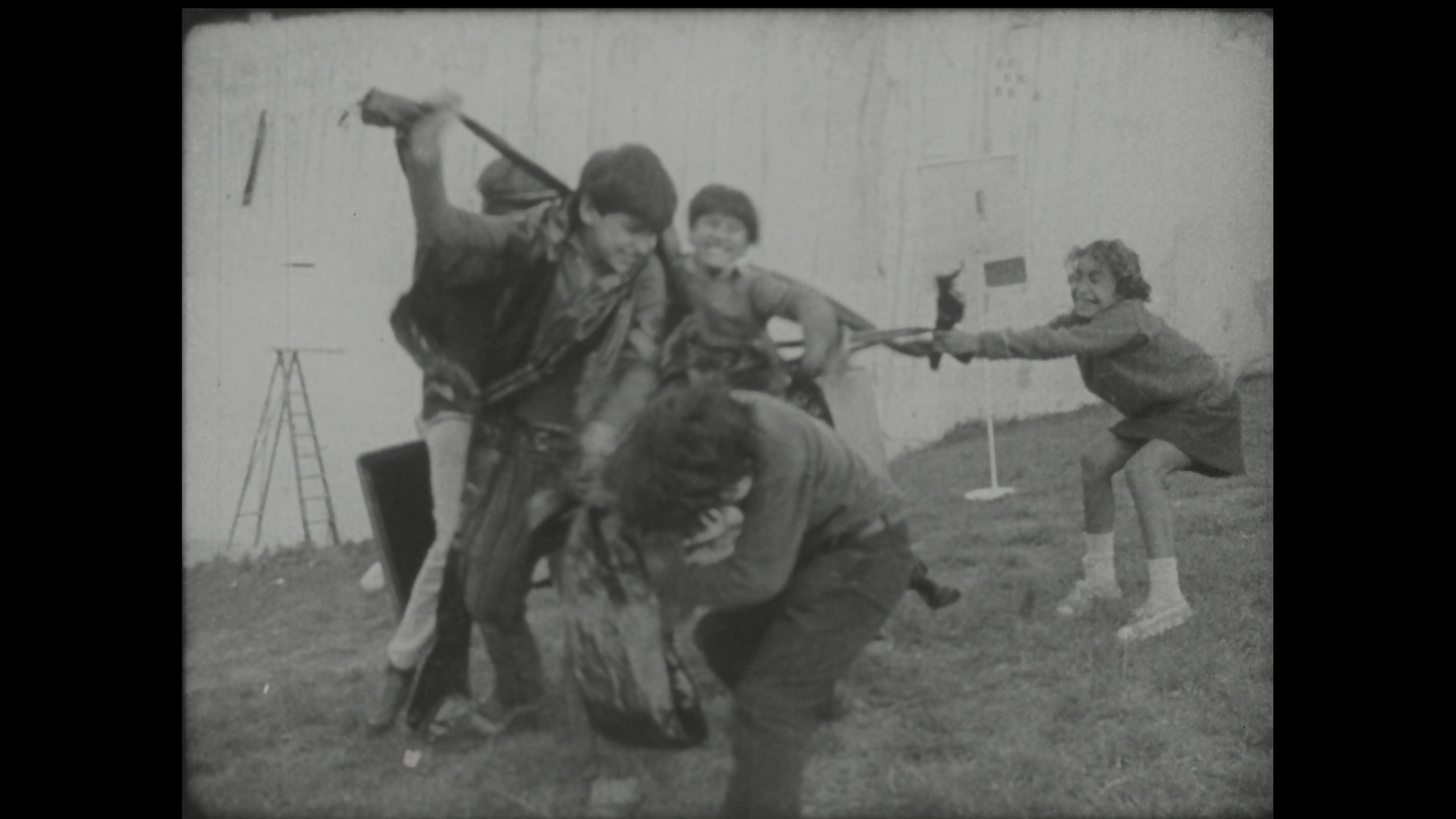 Black-and-white film still of public art event
