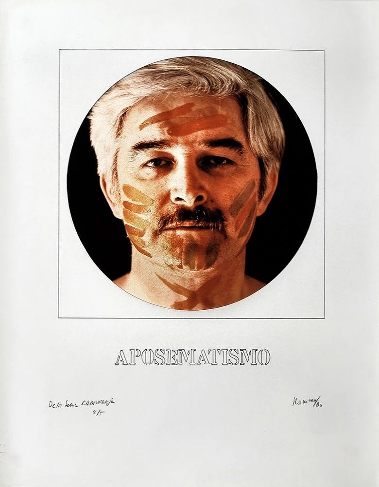 A series of four works on paper is laid out here in a grid. In the lower right corner, a head-on photograph of the artist, Juan Carlos Romero, shows his face covered in thick horizontal stripes of orange and green paint. An orange X is painted over his throat, and red tears are painted below his eyes. The caption reads “APOSEMATISMO.”