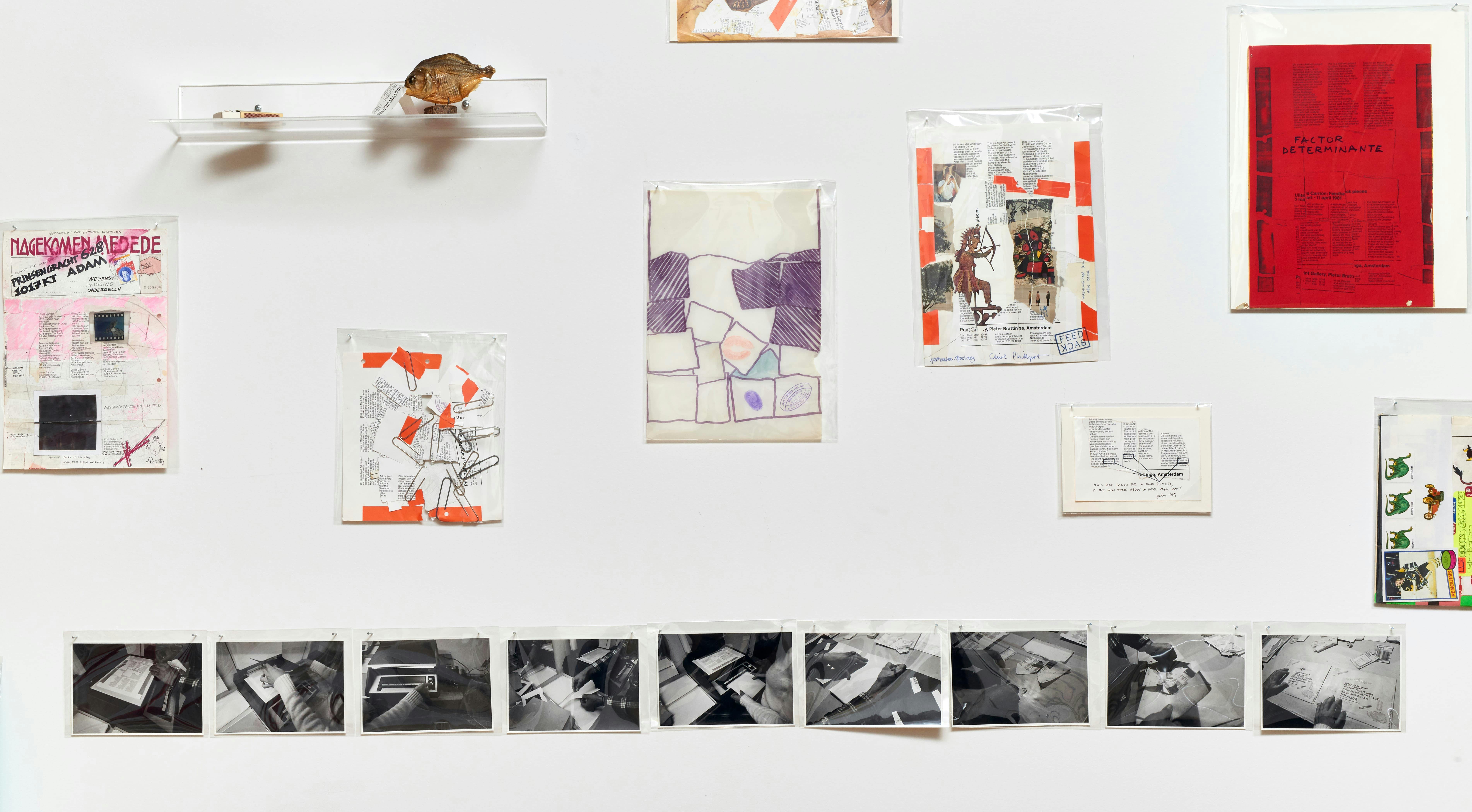 Installation view of Ulises Carrión exhibition showing small collages of varying size and photographs mounted to a white wall.