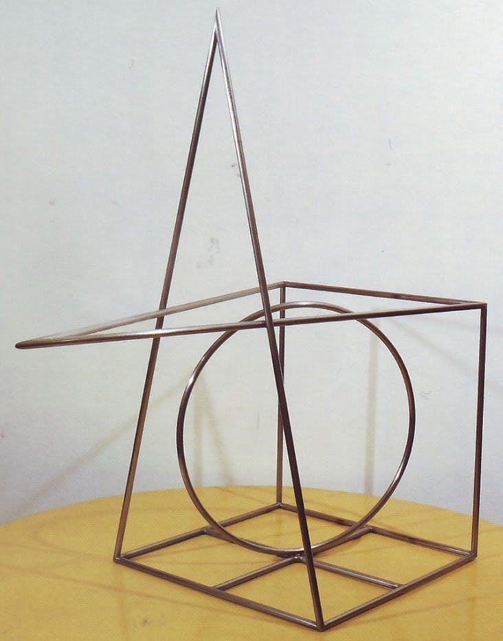 An iron, geometric sculpture made of thin metal rod.