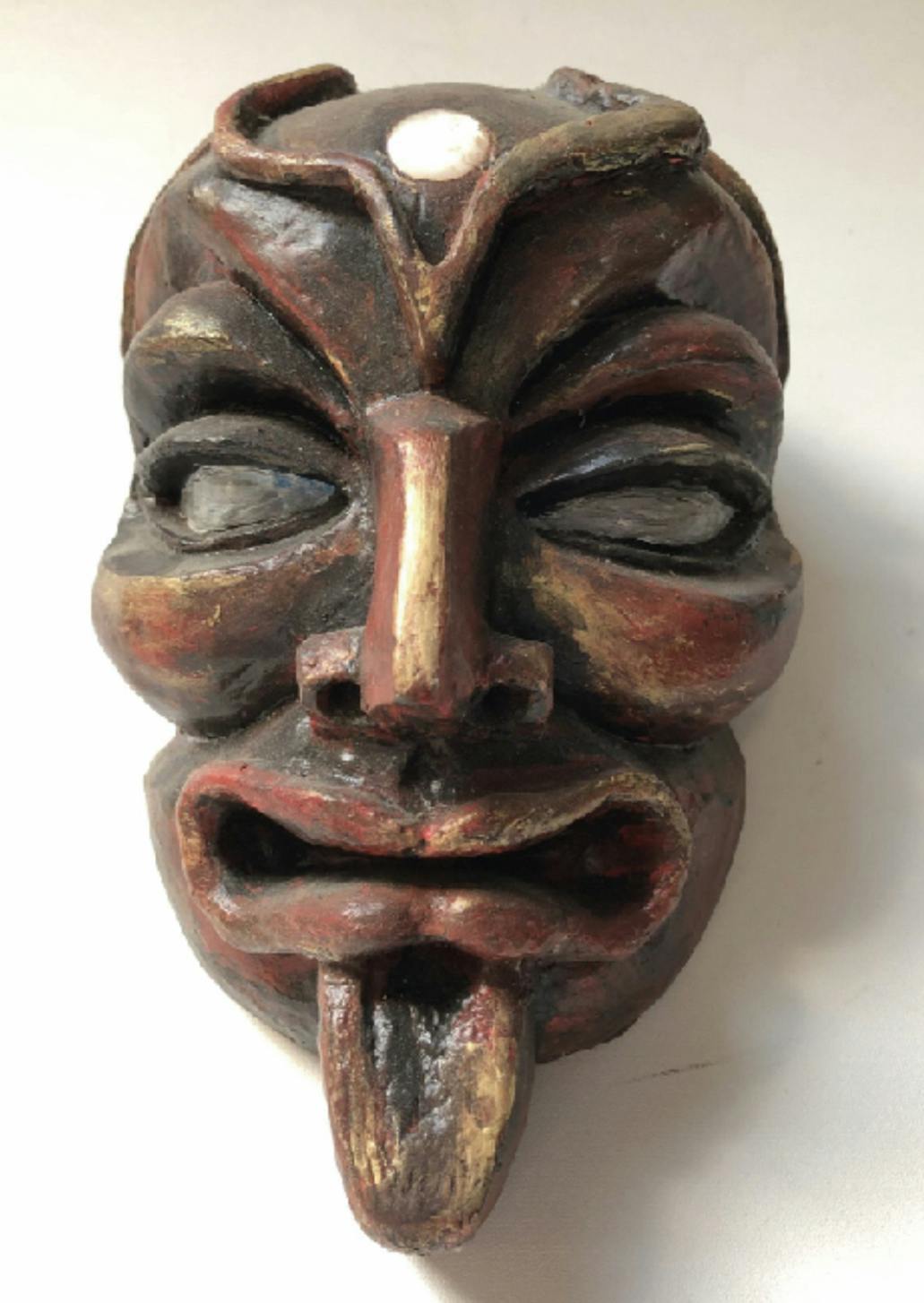 A ceramic sculpture of a mask.