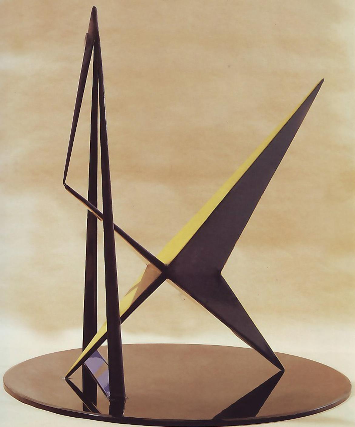 A geometric, metal sculpture painted black and yellow.