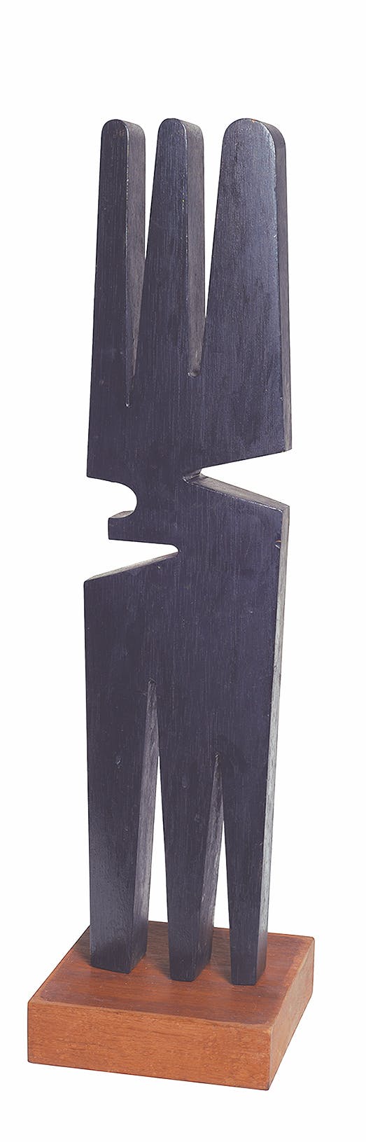 An abstract, black sculpture on a wood platform.