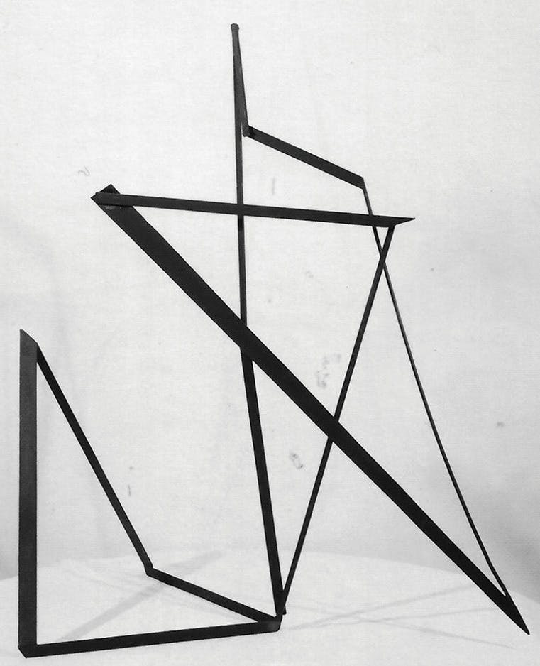 A black, geometric sculpture made of thin iron ribbon.