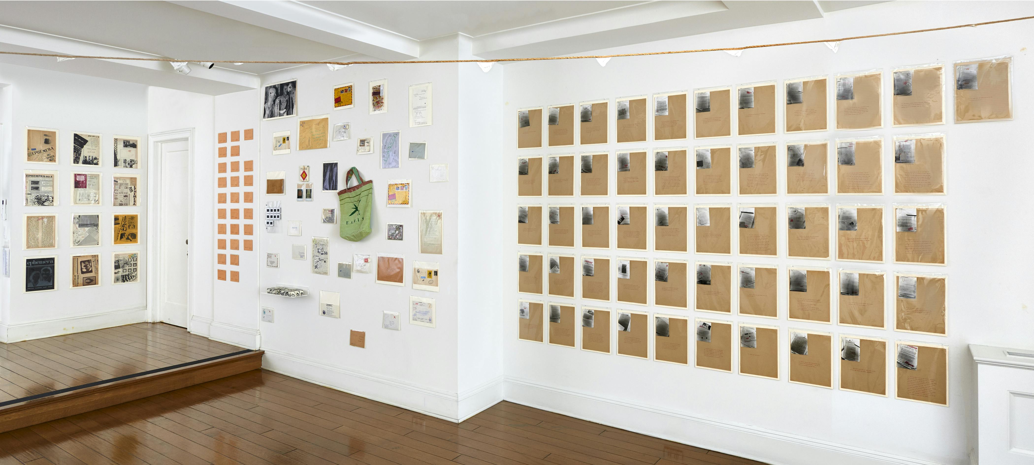 Installation view of Ulises Carrión: The Big Monster exhibition showing a large amount of wall-mounted works.