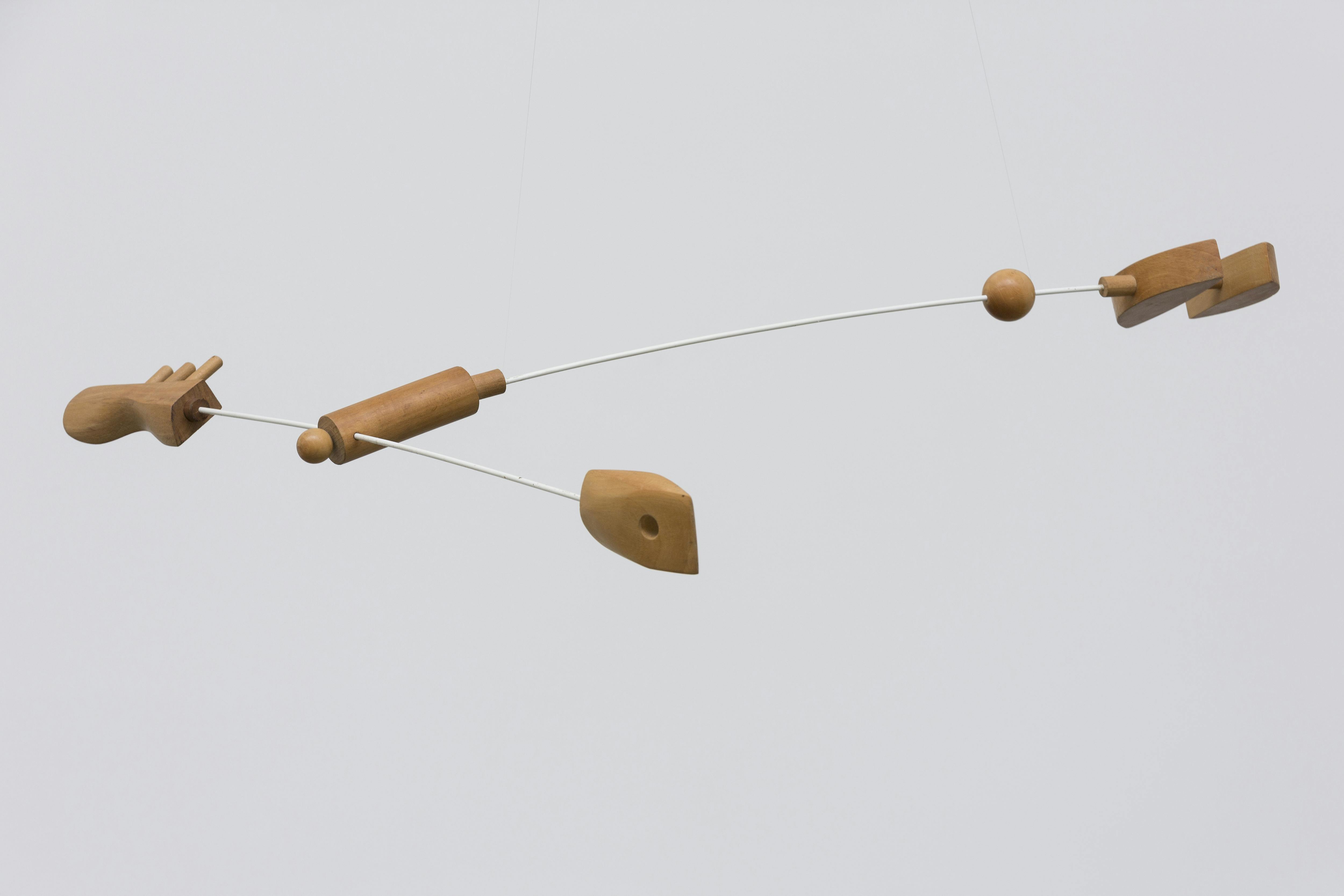 Image of a wood and metal mobile sculpture by Carmelo Arden Quin.