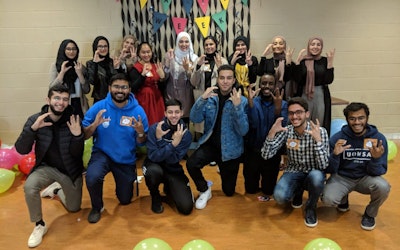 Volunteers in a group smiling at the camera