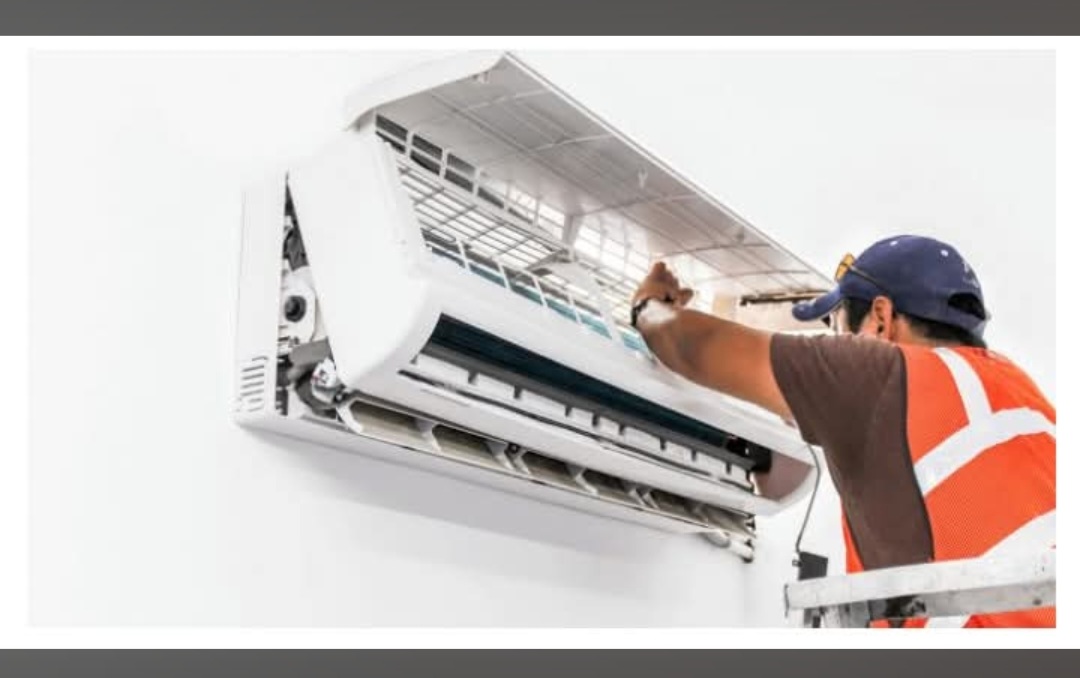 Andrew of Island Engineering servicing a wall-mounted air conditioning unit