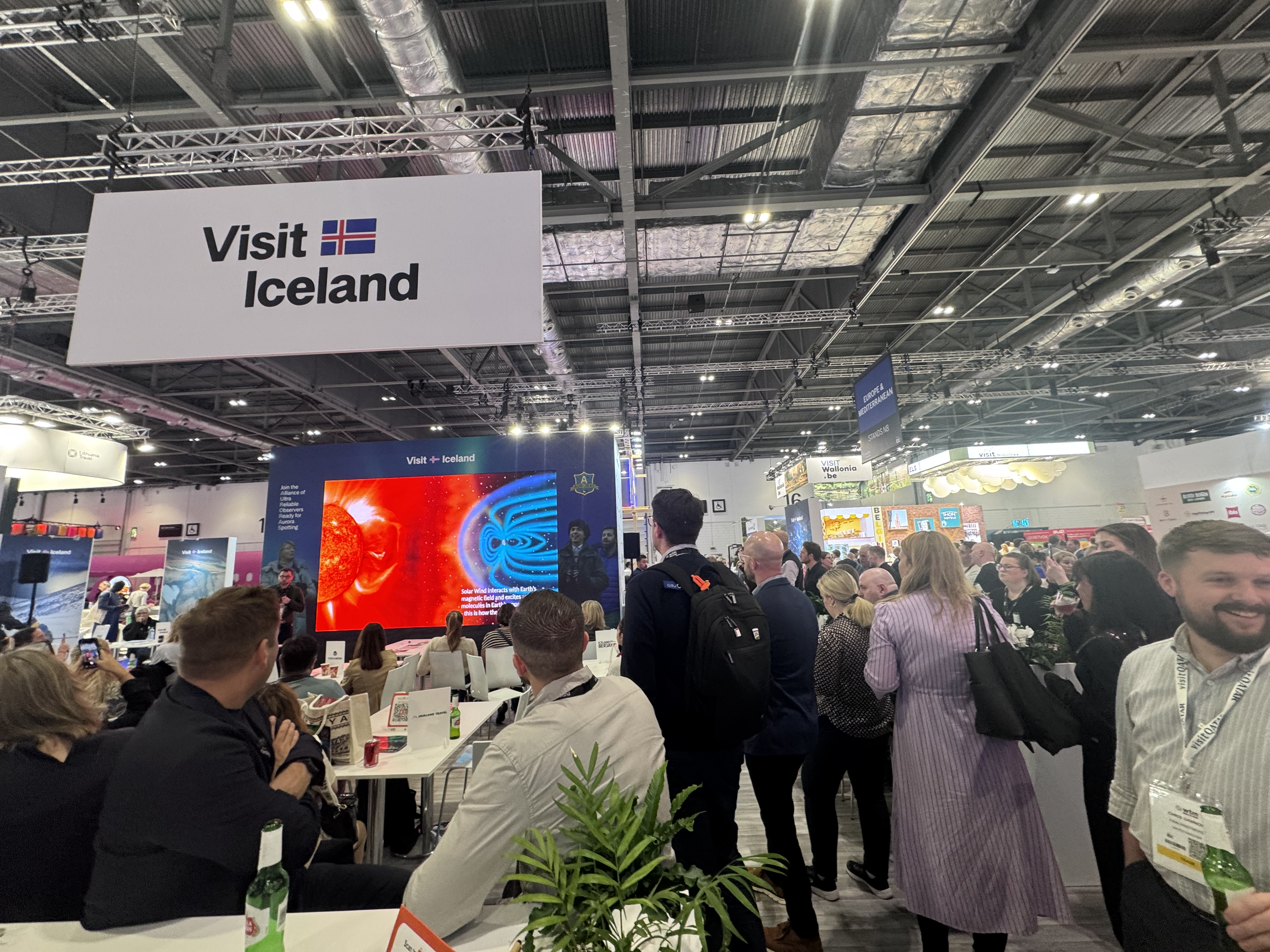 Visitors gather at Iceland’s stand under the Visit Iceland banner during World Travel Market 2025, surrounded by bright displays and networking activity.
