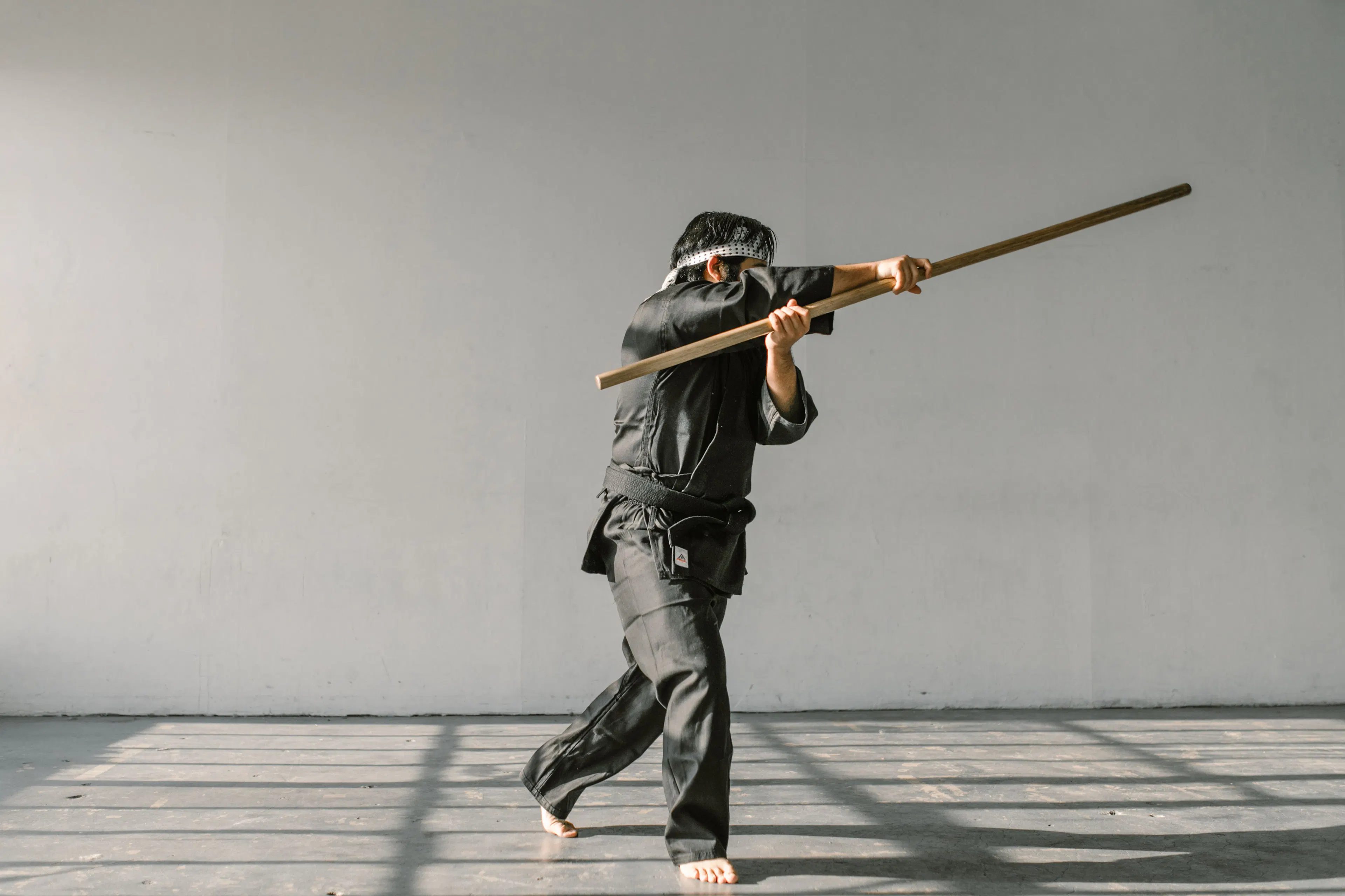 Silambam practitioner performing a bamboo staff technique