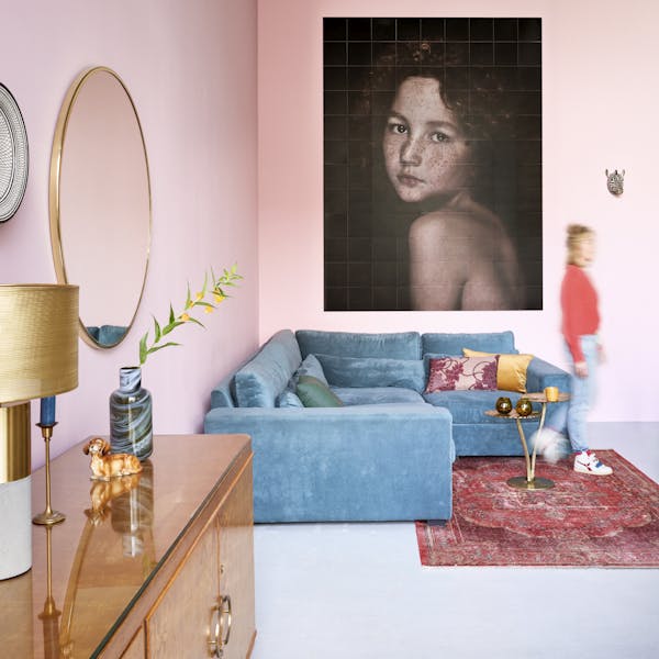 Photo enlargement in a living room with a large blue sofa