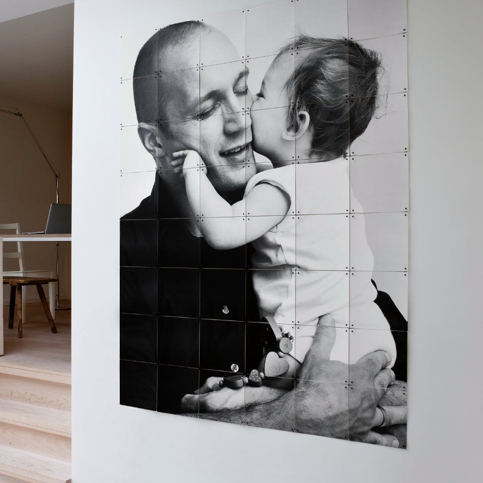 Fotovergroting in zwartwit met vader en kind naast trappetje
