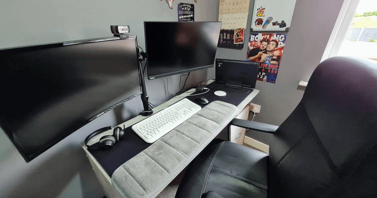 A desk with 2 monitors, a white keyboard and mouse and a bunch of other desk accessories