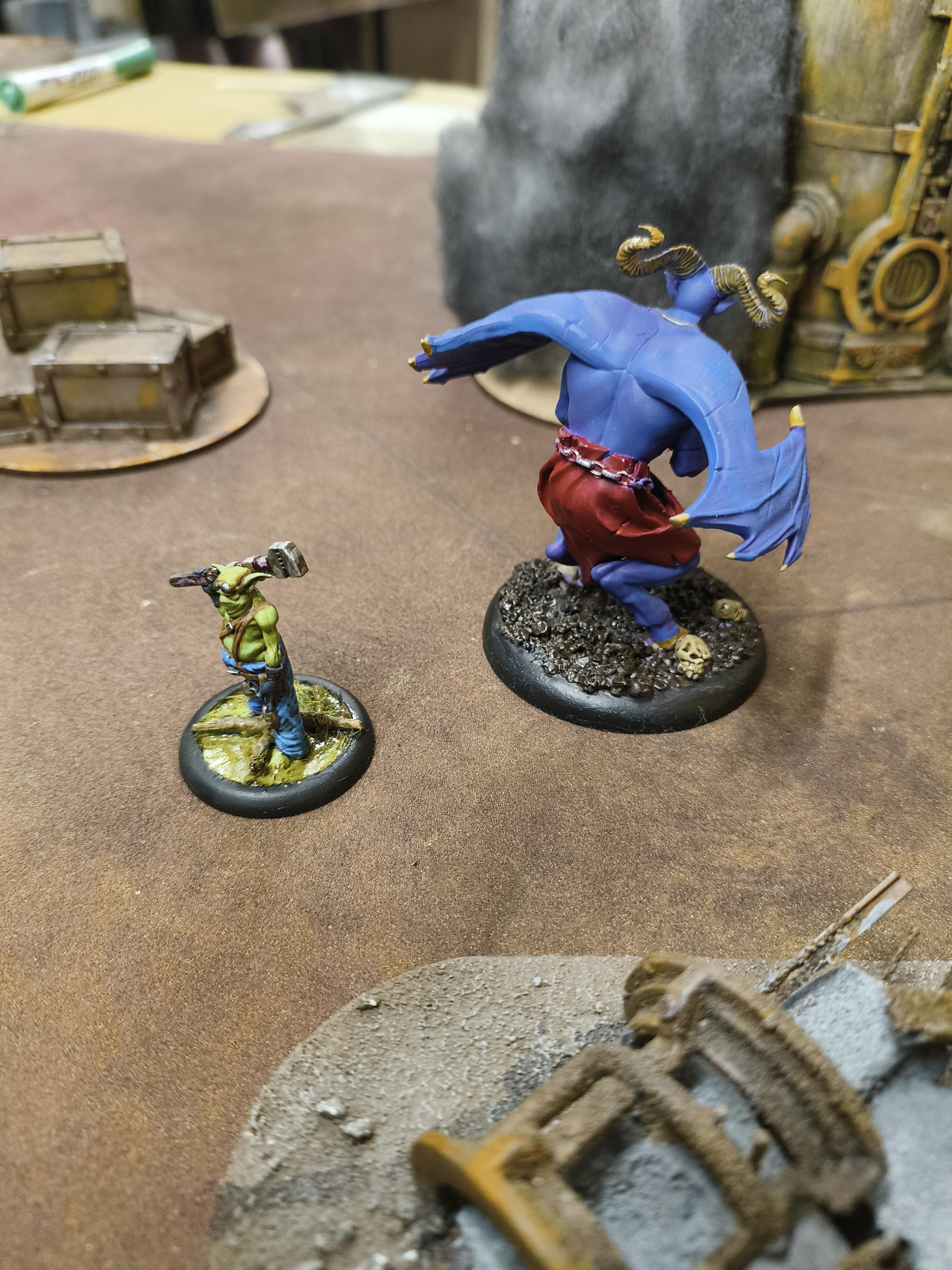 A Kastore model and a Sparks LeBlanc model on a Malifaux Board.