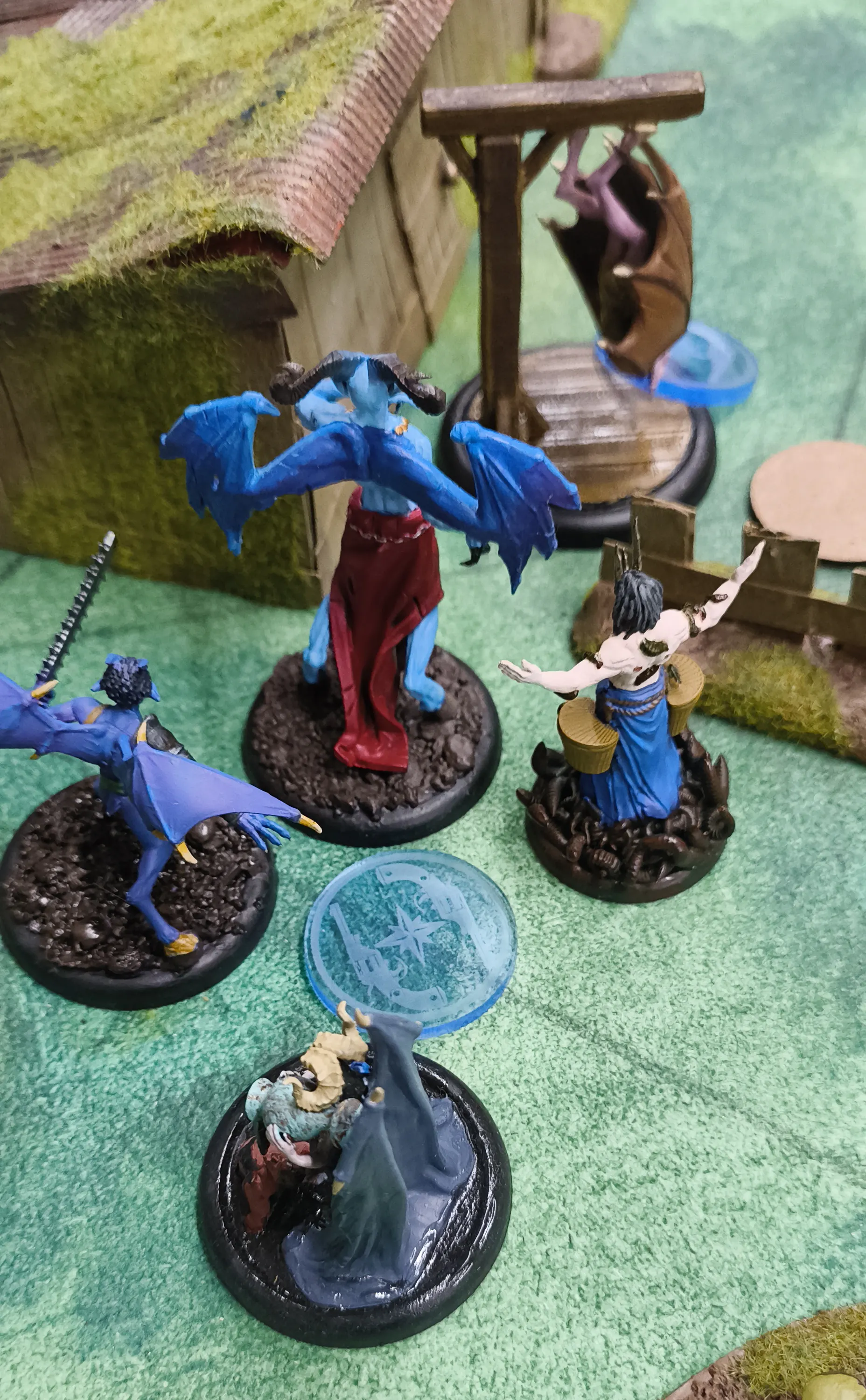 Some Malifaux Returned models, clustered around an Assault marker