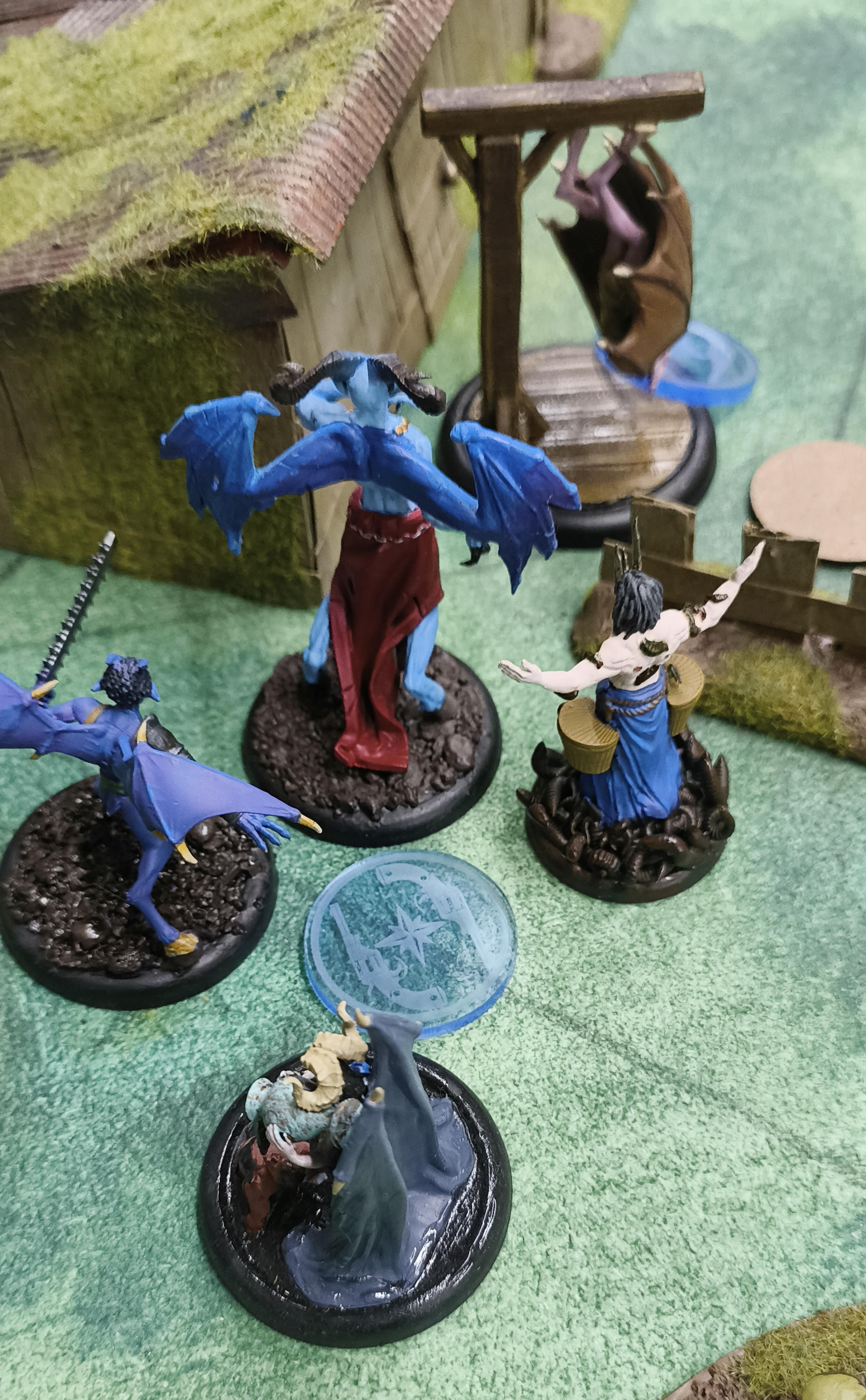 Some Malifaux Returned models, clustered around an Assault marker
