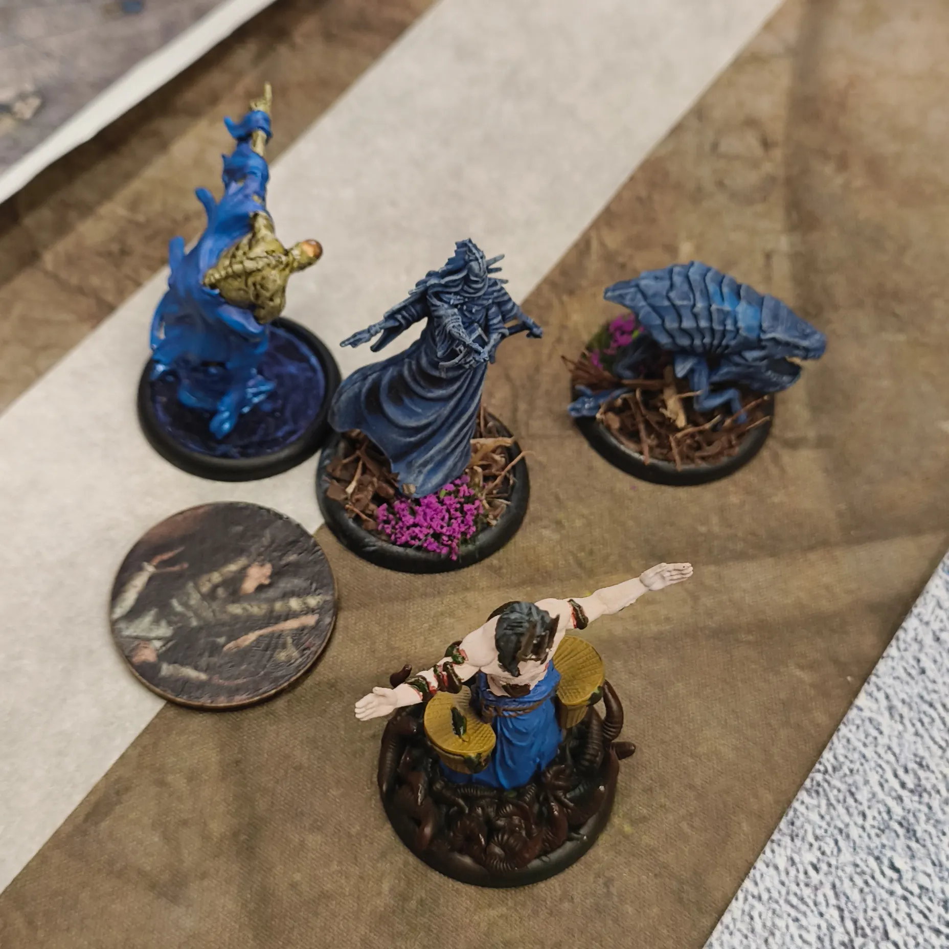 Some buried Malifaux models, at the side of the board.