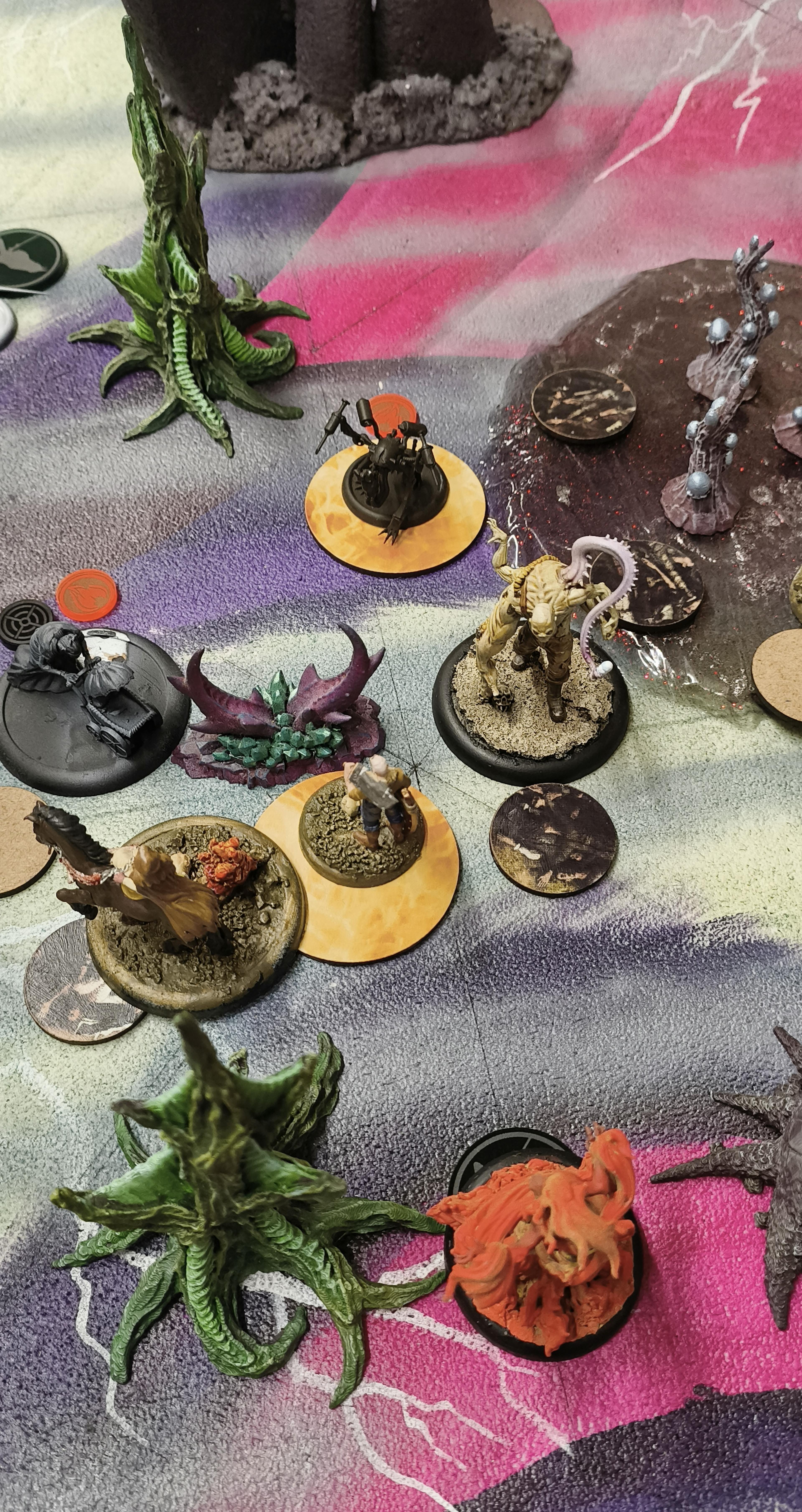 Malifaux models on pyre markers