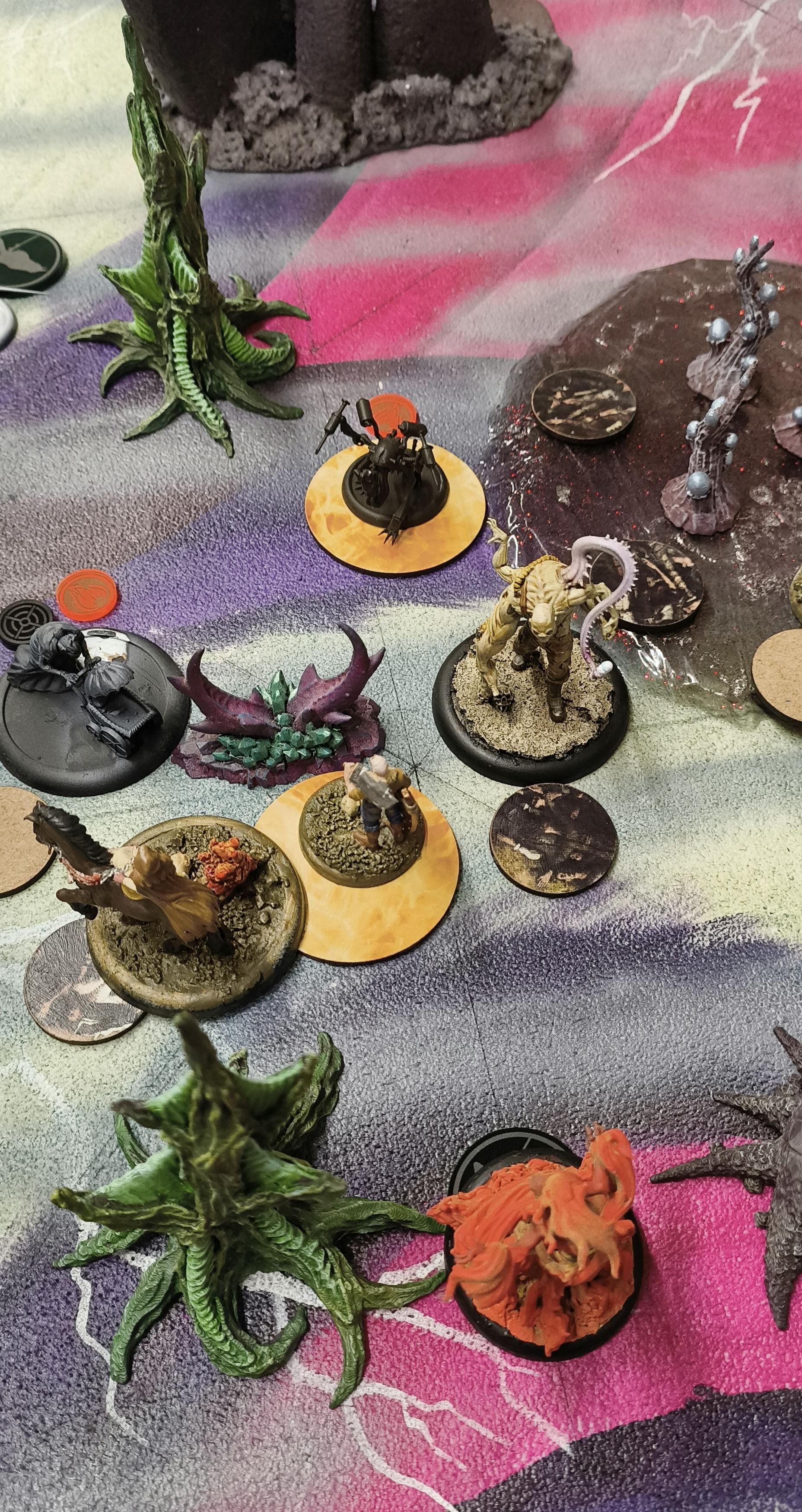 Malifaux models on pyre markers