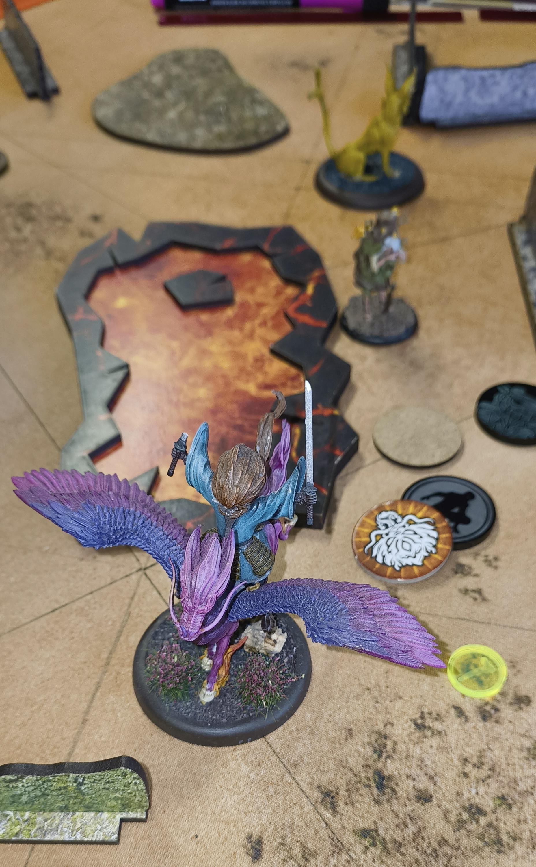 Malifaux models near a Strategy marker.