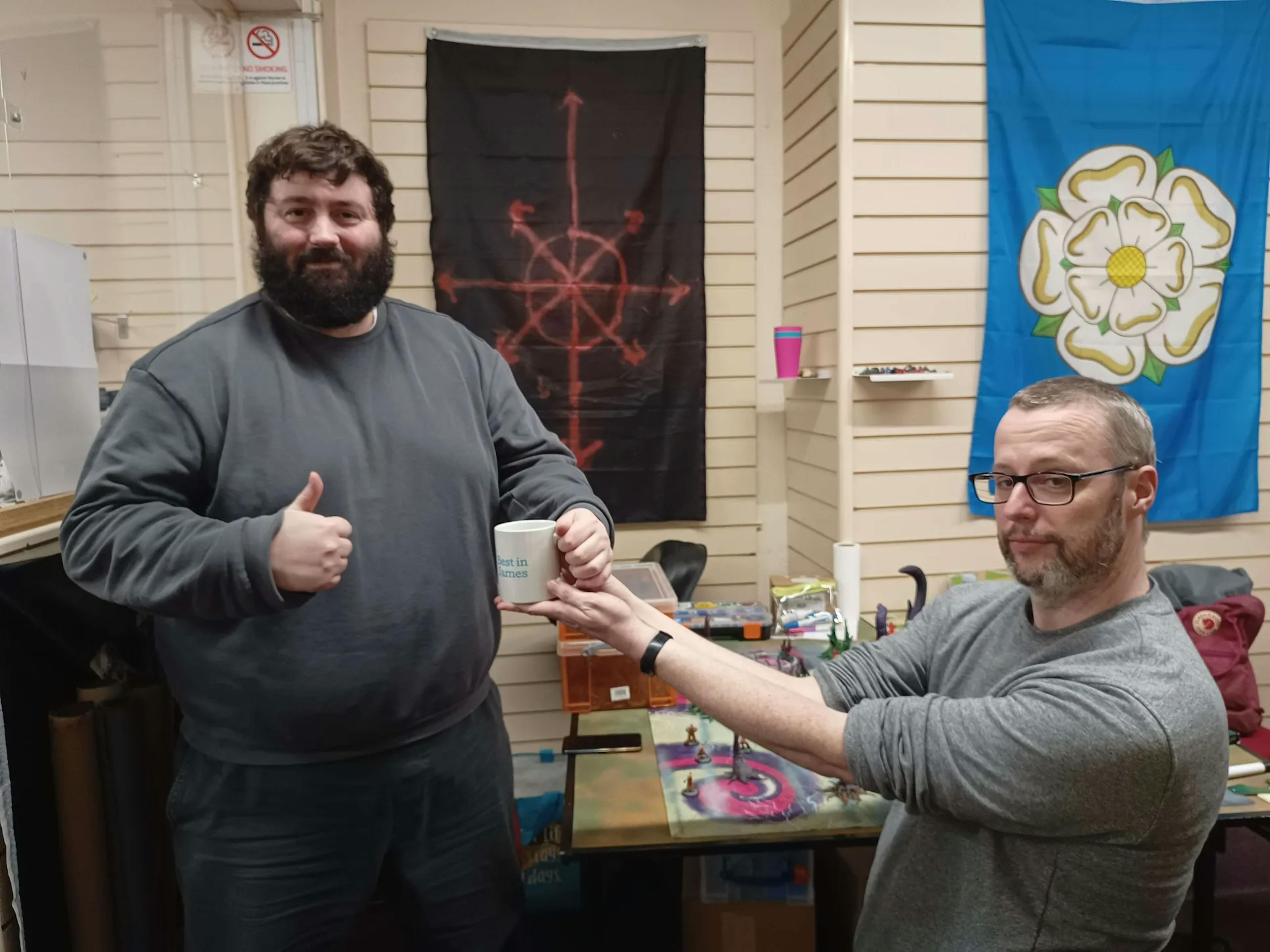 One James handing a trophy to another
