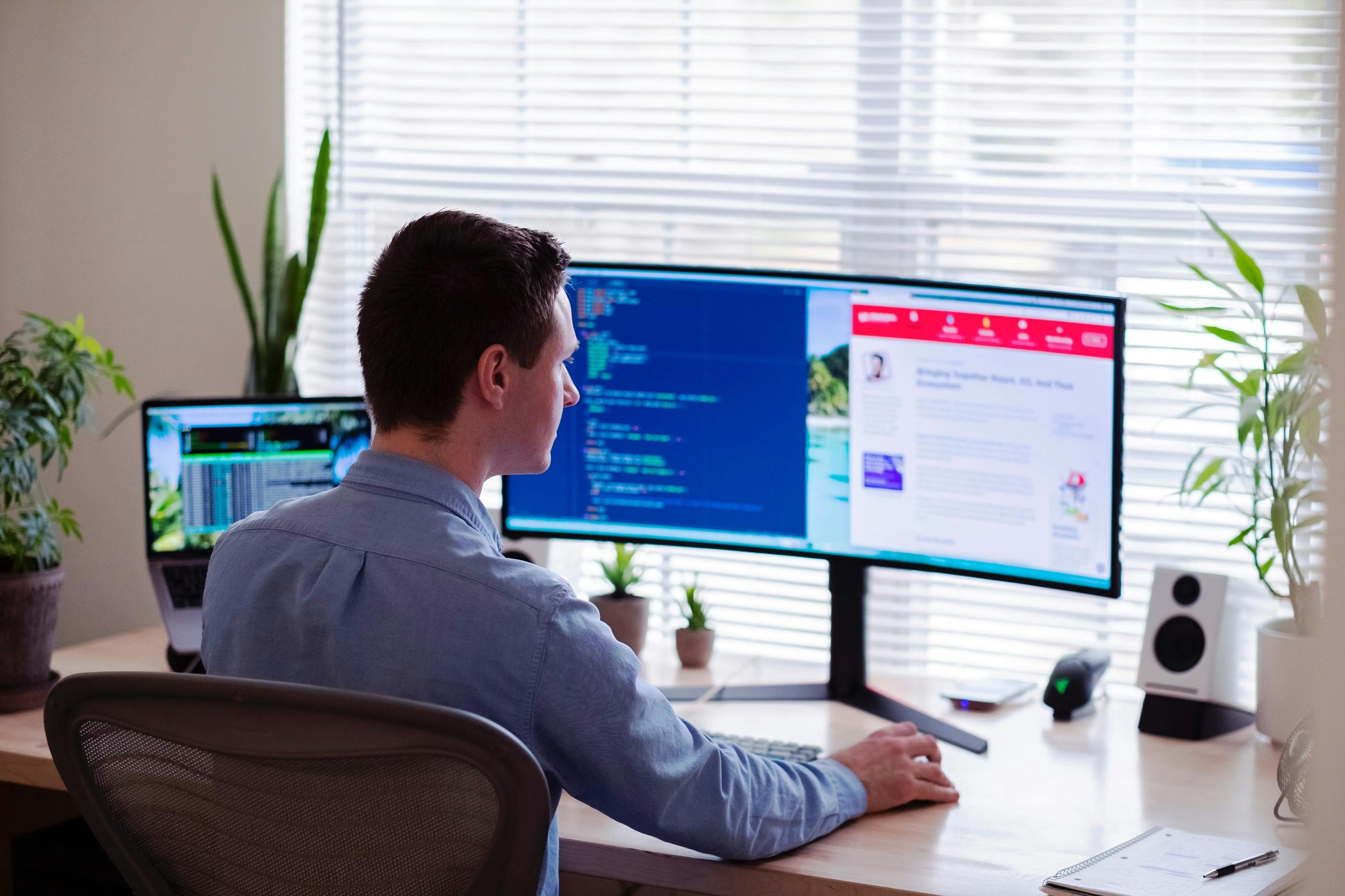 Guy coding at his desk