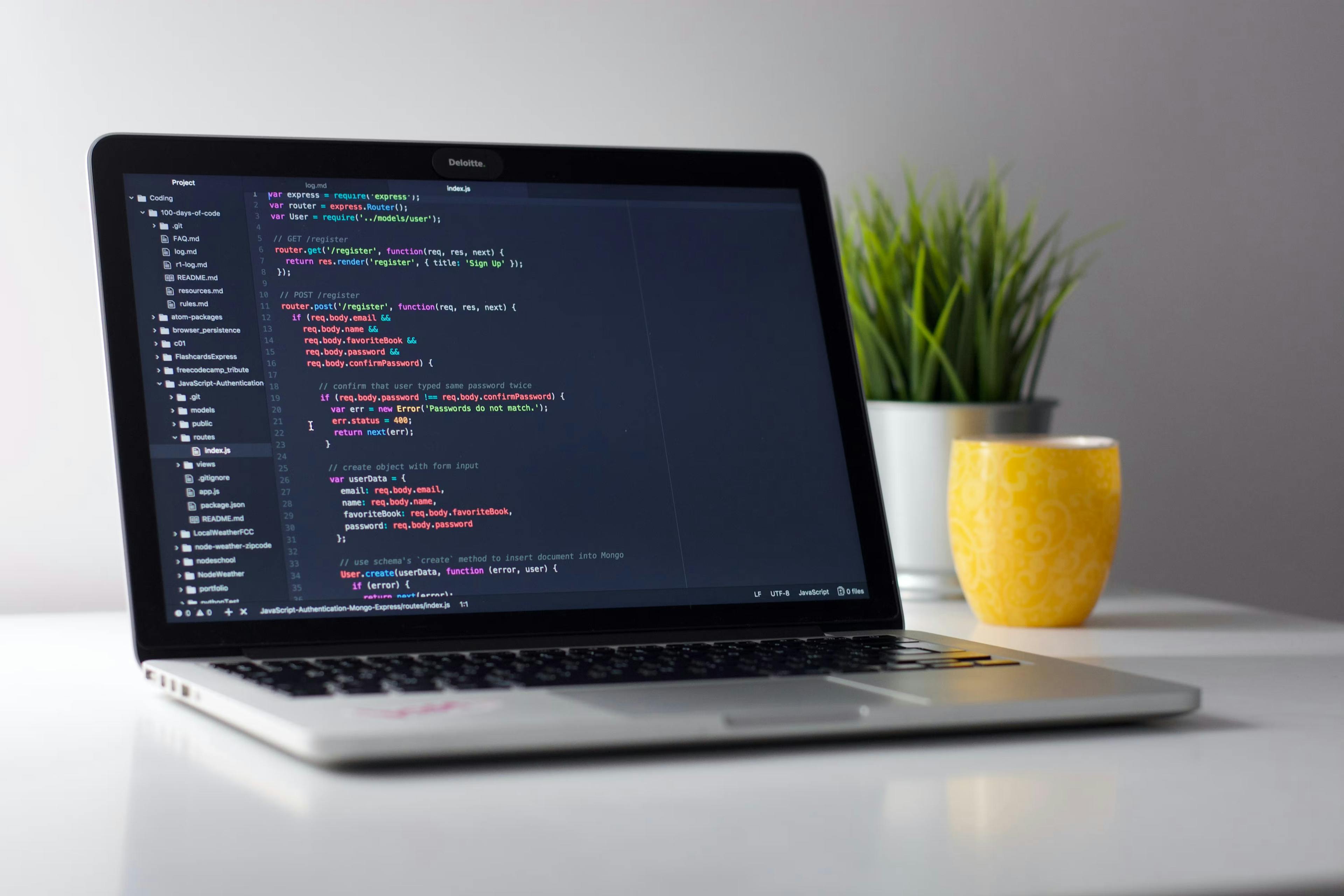 Laptop with code on the screen on a desk