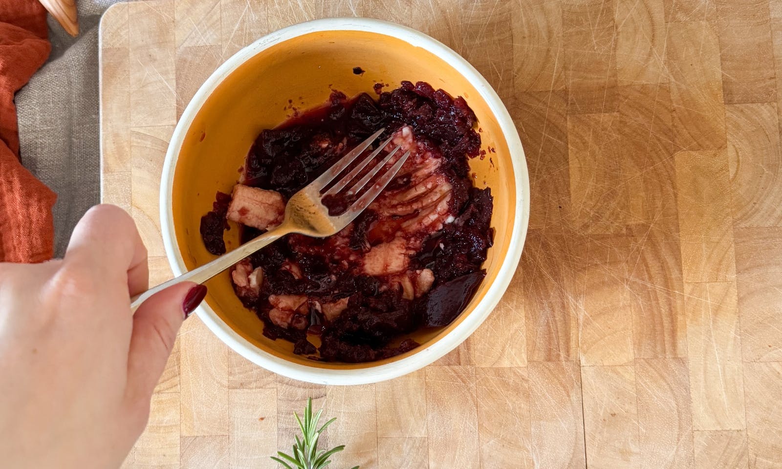 Rote Beete und Banane werden mit einer Gabel zerdrückt als Vorbereitung für Hundeleckerlis