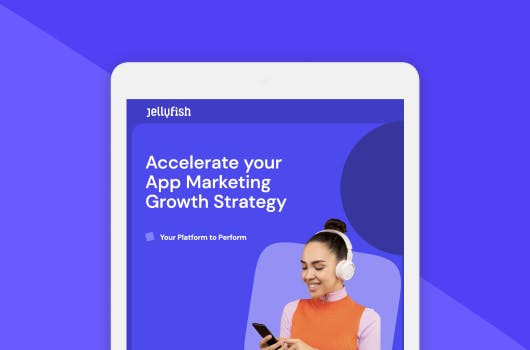 A white iPad with a purple background, showing the front cover of the whitepaper. The front cover has the headline 'Accelerate Your App Marketing Growth Strategy' with a young woman wearing an orange top and wearing white headphones who is looking at her black iPhone and smiling.