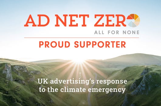 A sunrise coming up behind hills into a blue sky. The text reads Ad Net Zero proud supporter, UK's advertising response to the climate emergency
