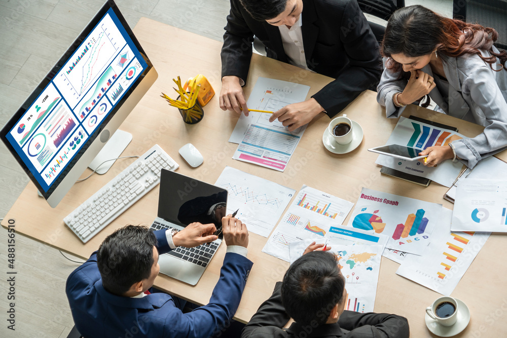 Business people working around a table with graphs and data