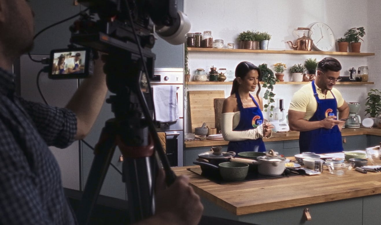 Video producer taking a video with Google branded aprons 