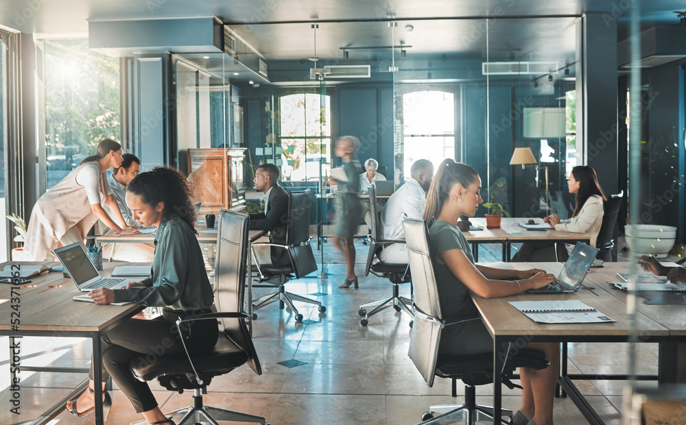 Office setting with professionals working on desks