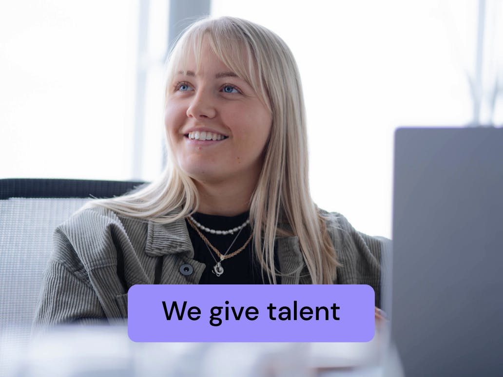 image of jellyfish team member at computer with "we give talent" text overlaid
