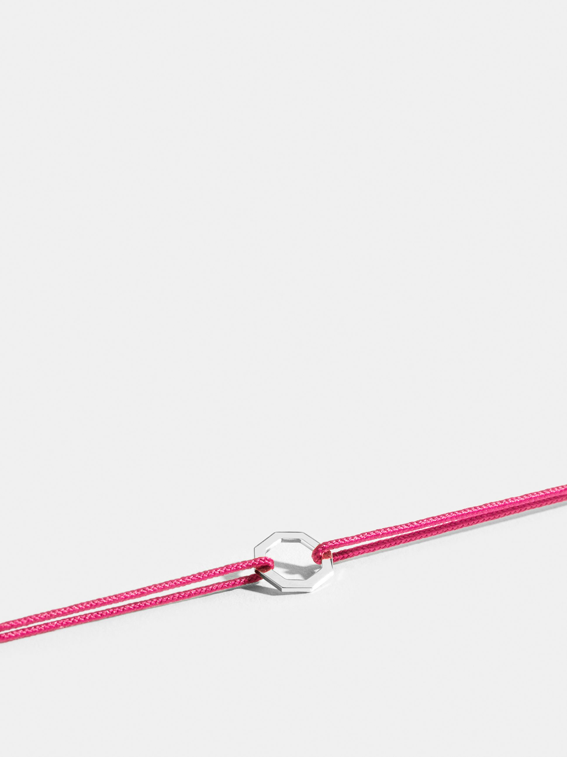 Octogone motif in 18k Fairmined ethical white gold, on a fuschia pink cord.