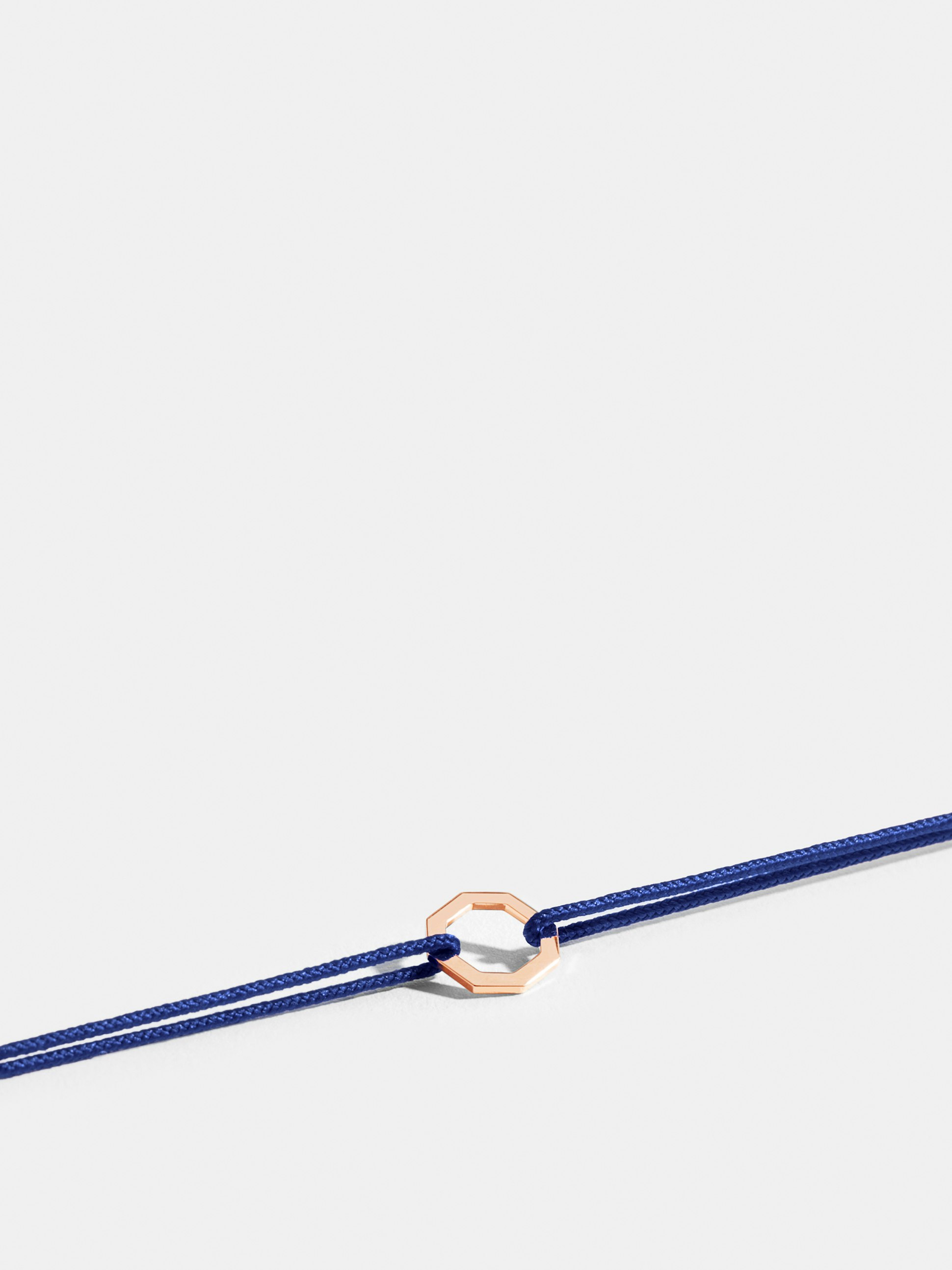 Octogone motif in 18k Fairmined ethical rose gold, on a klein blue cord. 