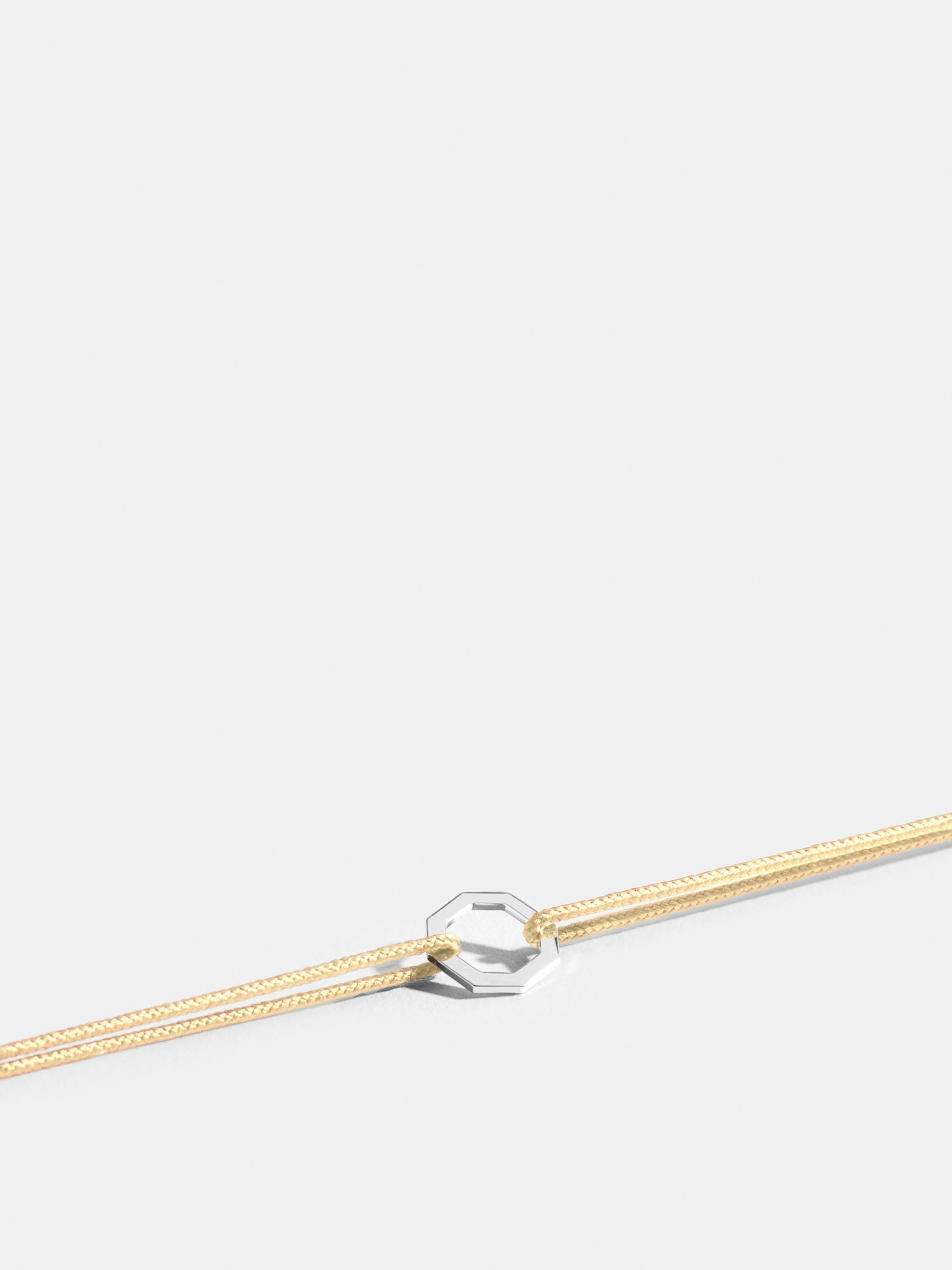 Octogone motif in 18k Fairmined ethical white gold, on an ivory white cord. 
