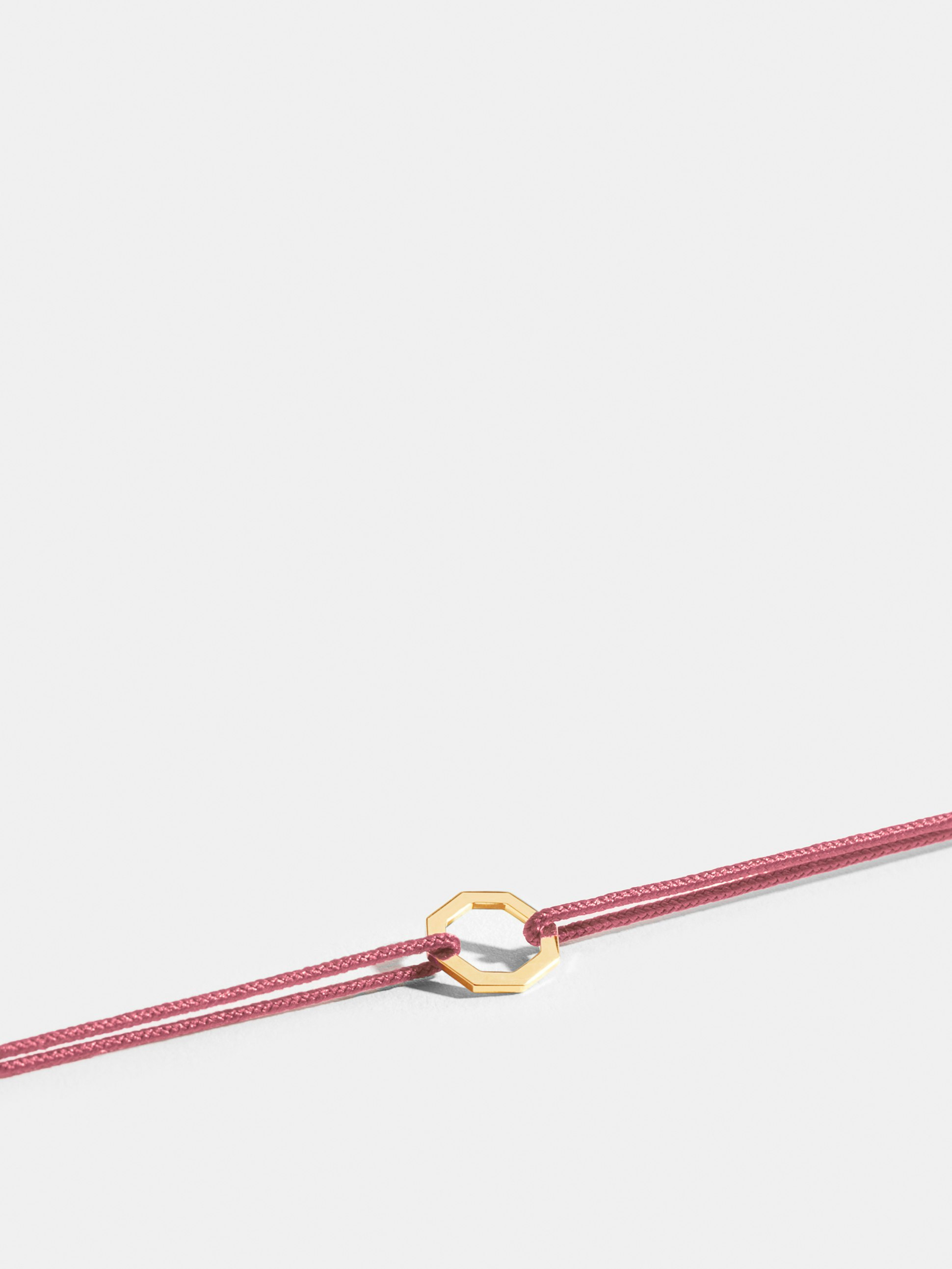 Octogone motif in 18k Fairmined ethical yellow gold, on an antique pink cord. 