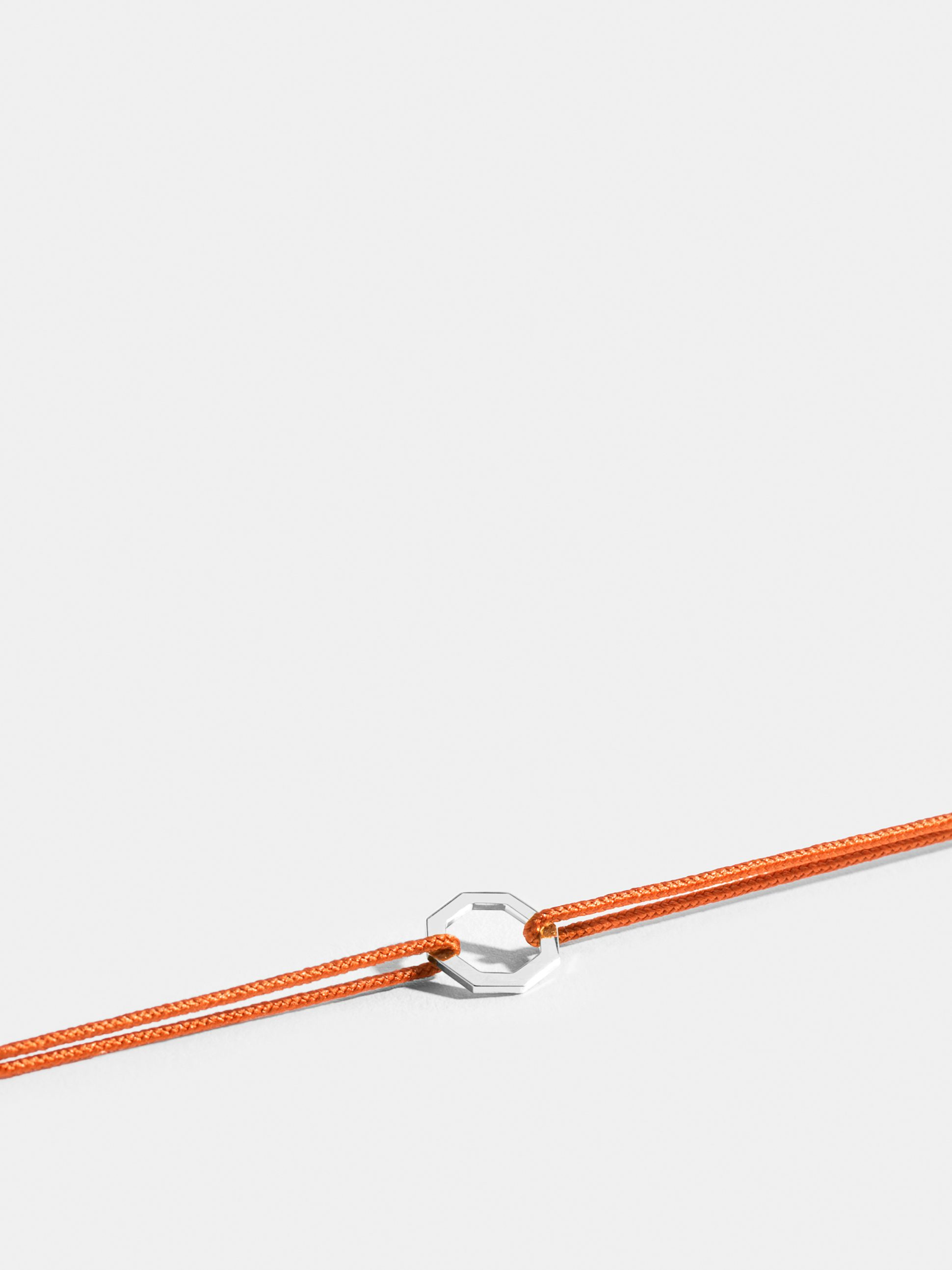 Octogone motif in 18k Fairmined ethical rose gold, on a bright orange cord. 