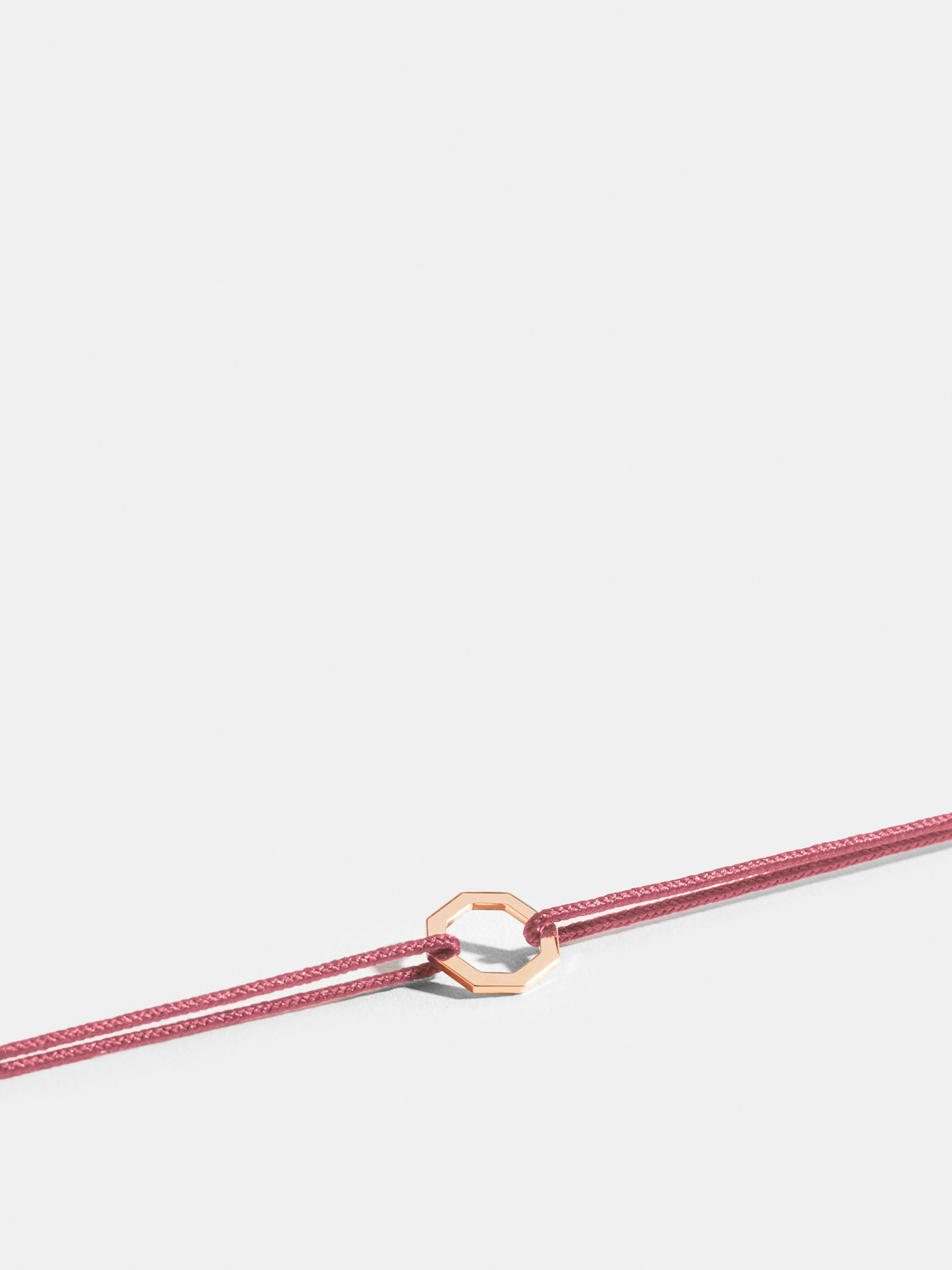 Octogone motif in 18k Fairmined ethical rose gold, on an antique pink cord. 
