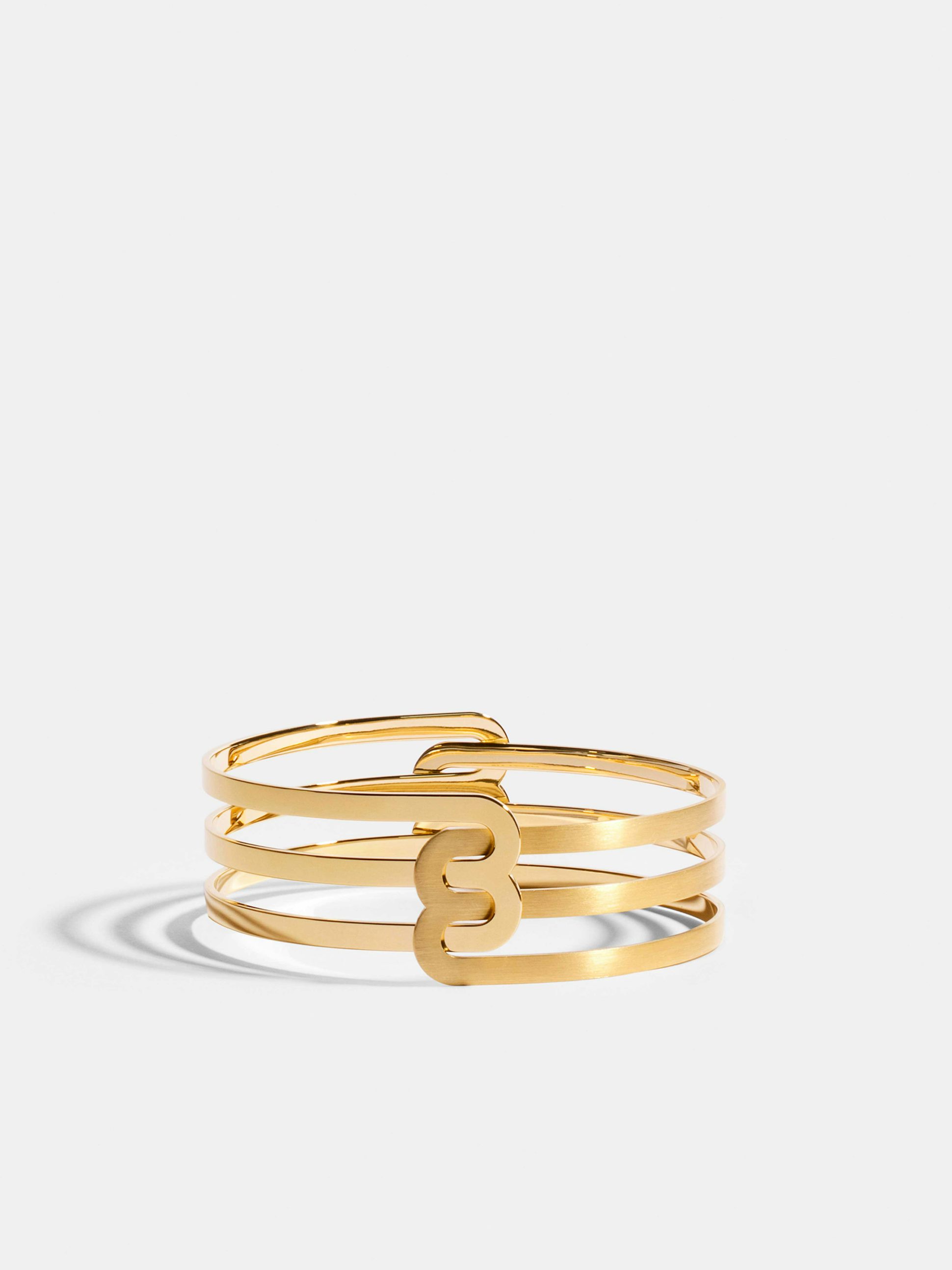 Bracelet Étreintes en Or jaune éthique 18 carats certifié Fairmined composé d'un demi-bracelet double finition poli-brillant et d'un demi-bracelet double finition brossée.