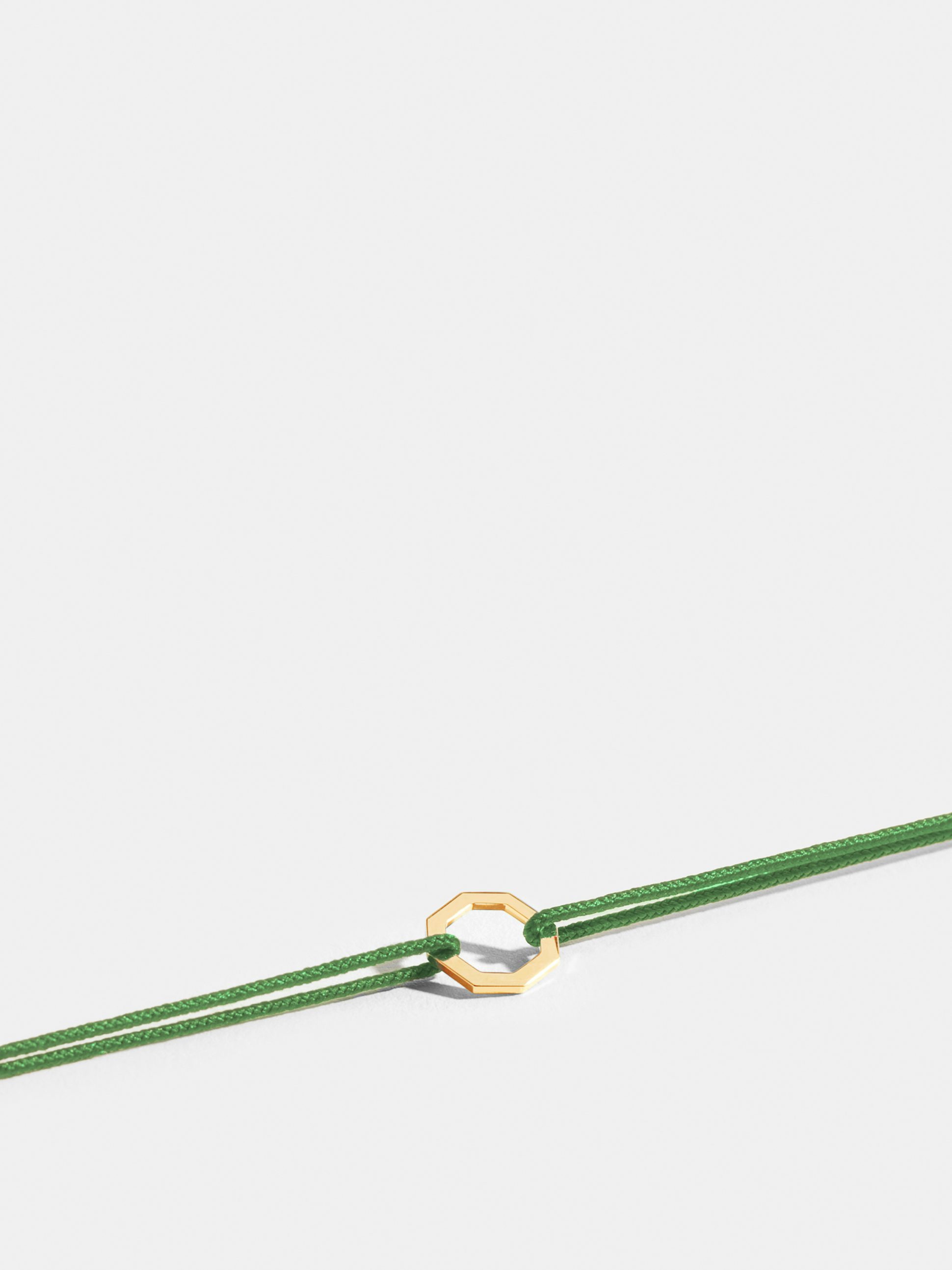 Octogone motif in 18k Fairmined ethical yellow gold, on an apple green cord. 